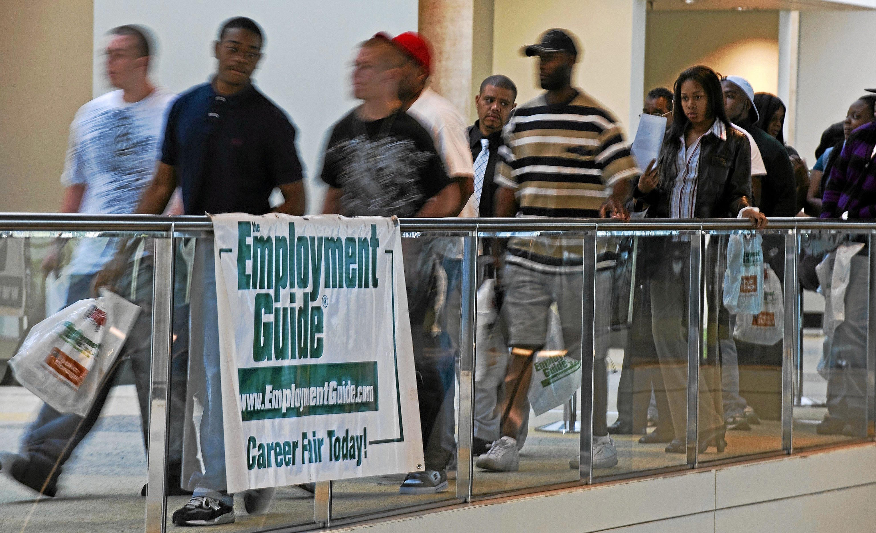 People seeking employment line up outside an job fair.