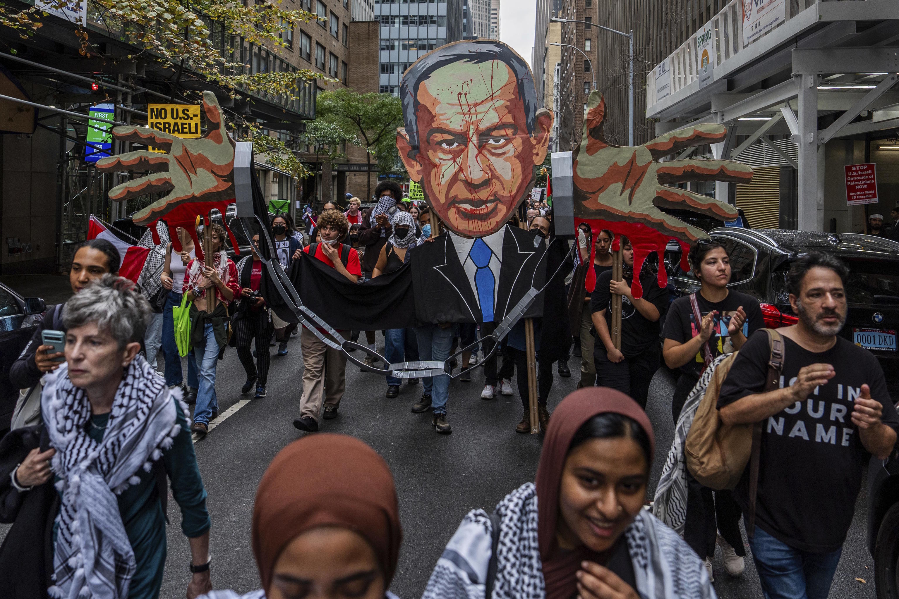 Palestinian supporters march at a protest against Netanyahu.