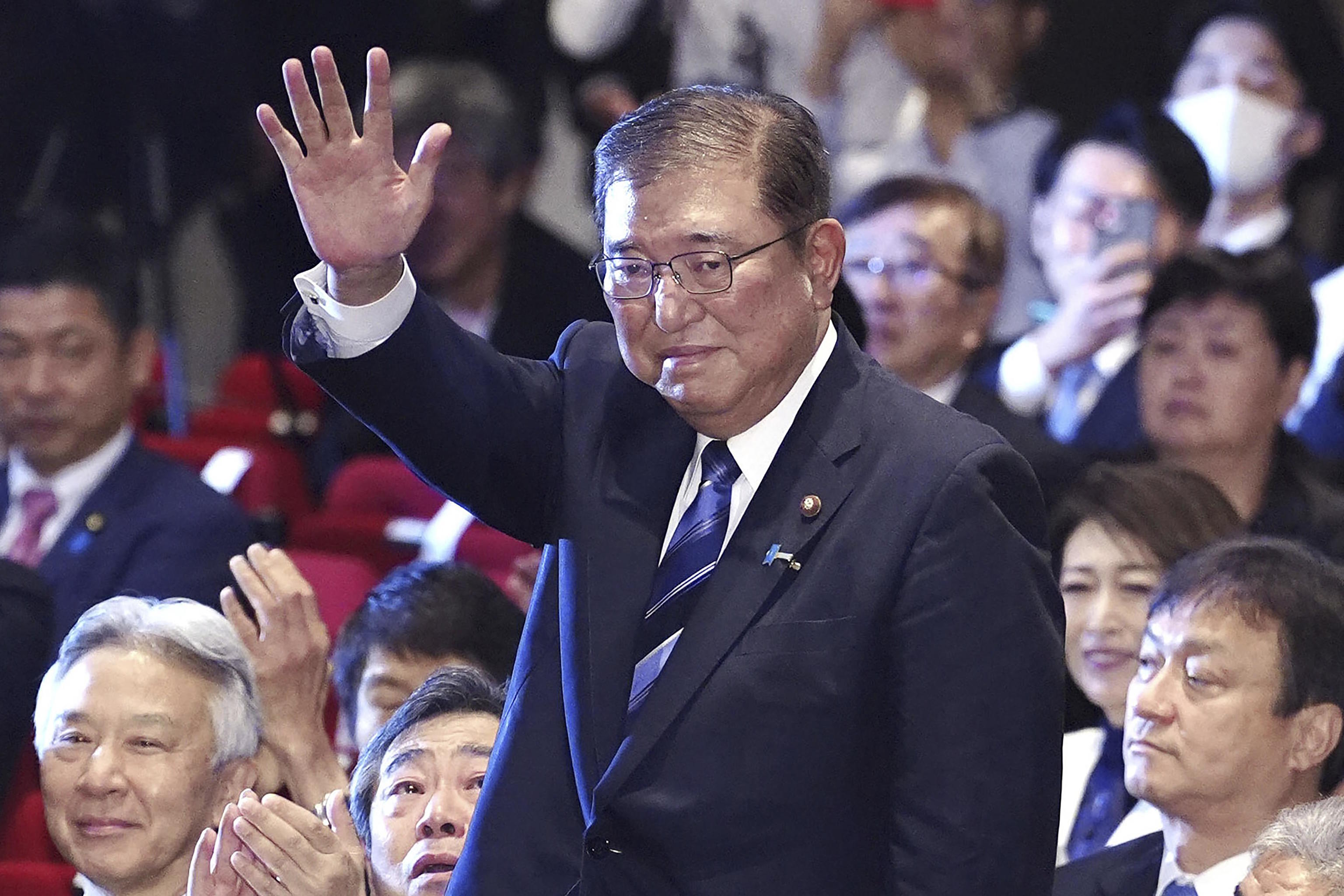 Ishiba waves as he is elected as leader of the ruling Liberal Democratic Party.