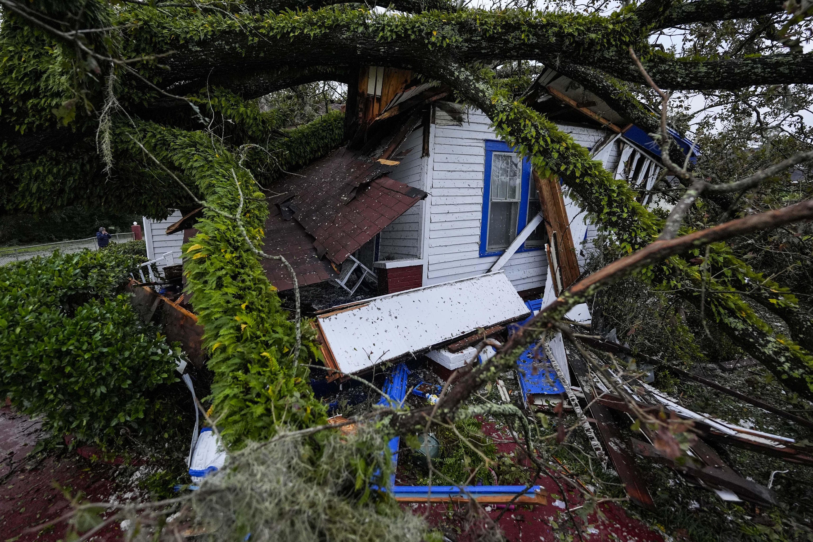 A damaged home is seen after an Oak tree landed on the home.