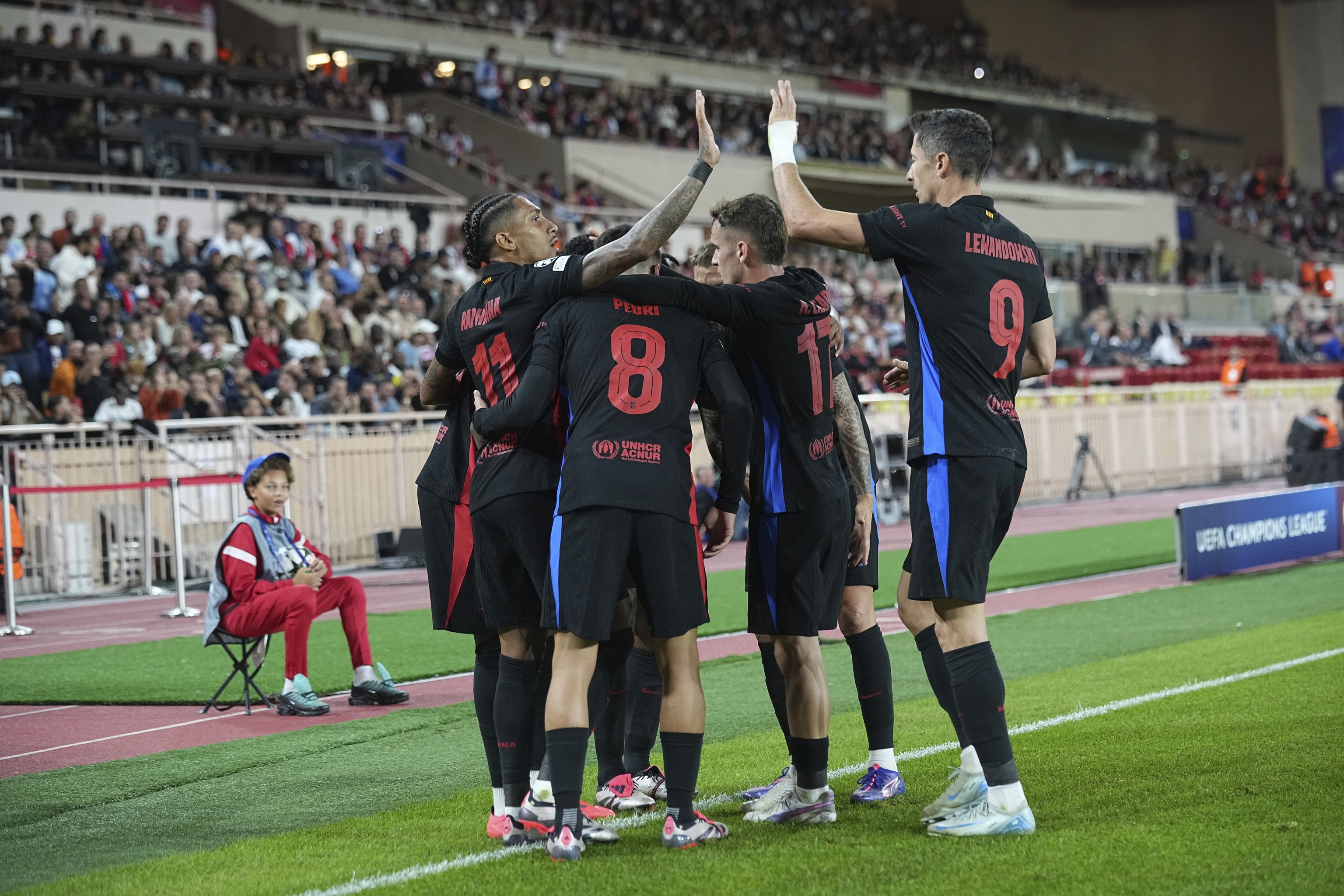 Barcelona players celebrate a goal against Monaco at Champions League.