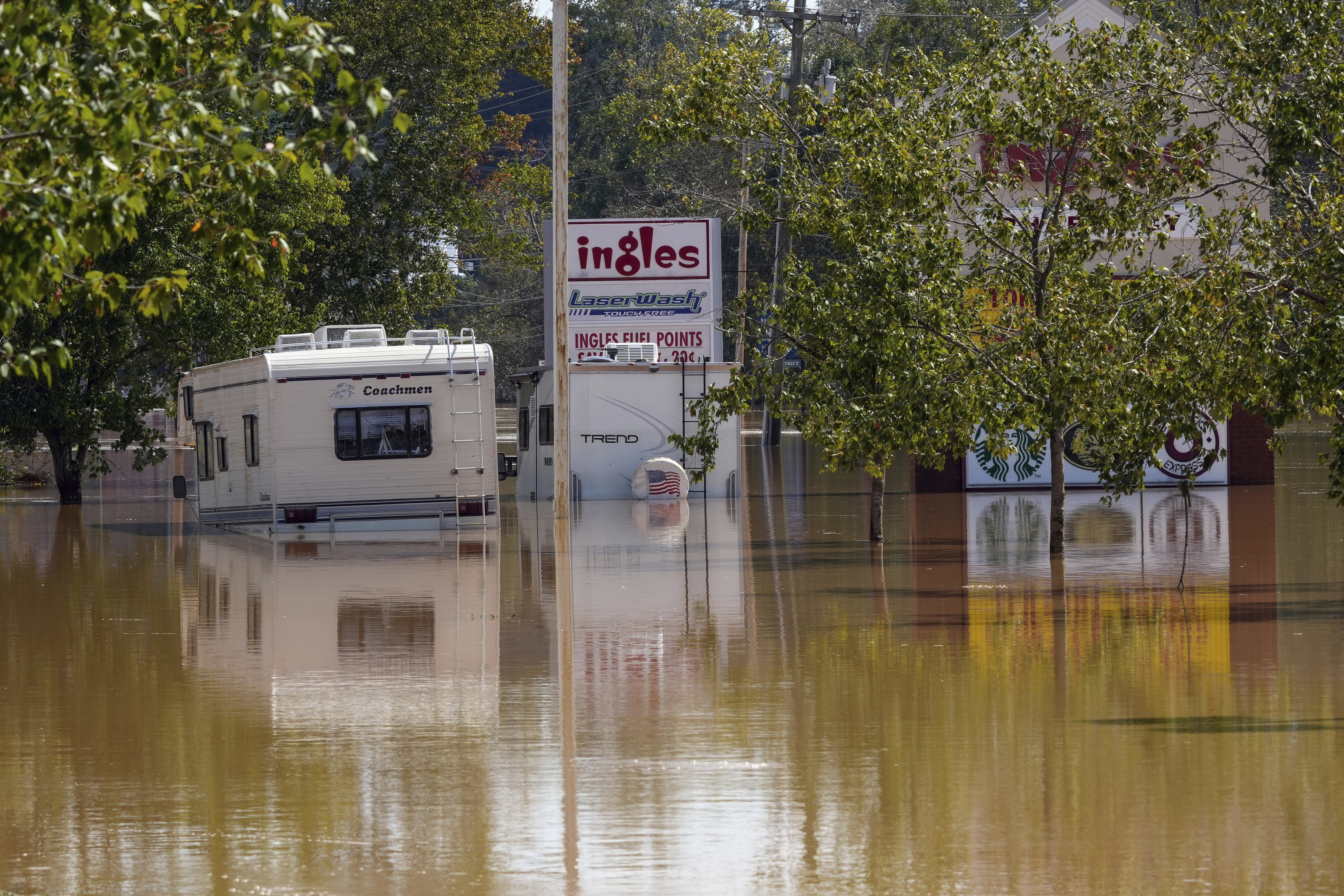 A couple of RVs are abandoned in the flooded Ingles parking lot due to the torrential rains from Hurricane Helene.