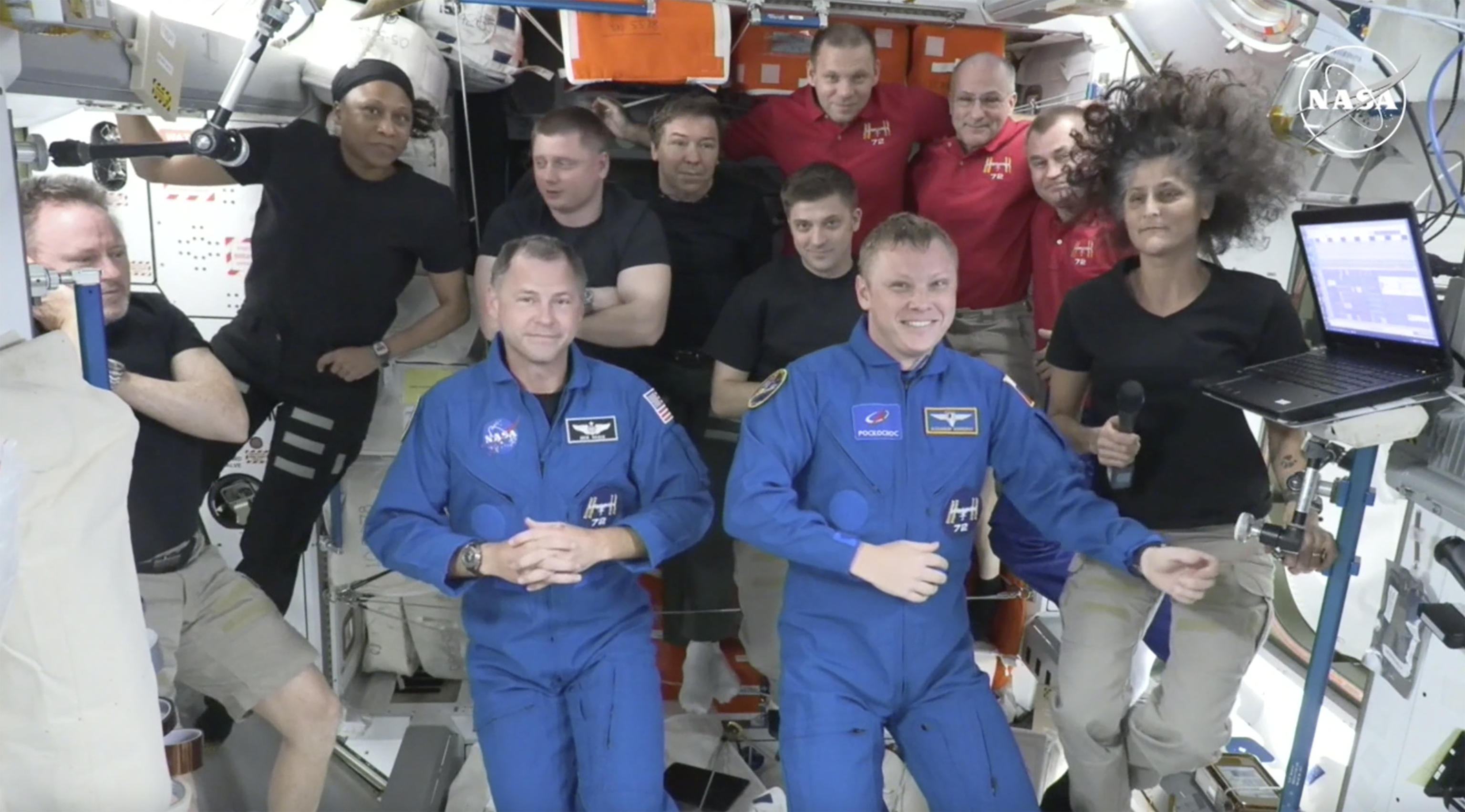 the two astronauts stuck at the International Space Station since June 2024, Butch Wilmore, far left, and Suni Williams, far right, welcome two new residents who flew up on SpaceX, NASA's Nick Hague