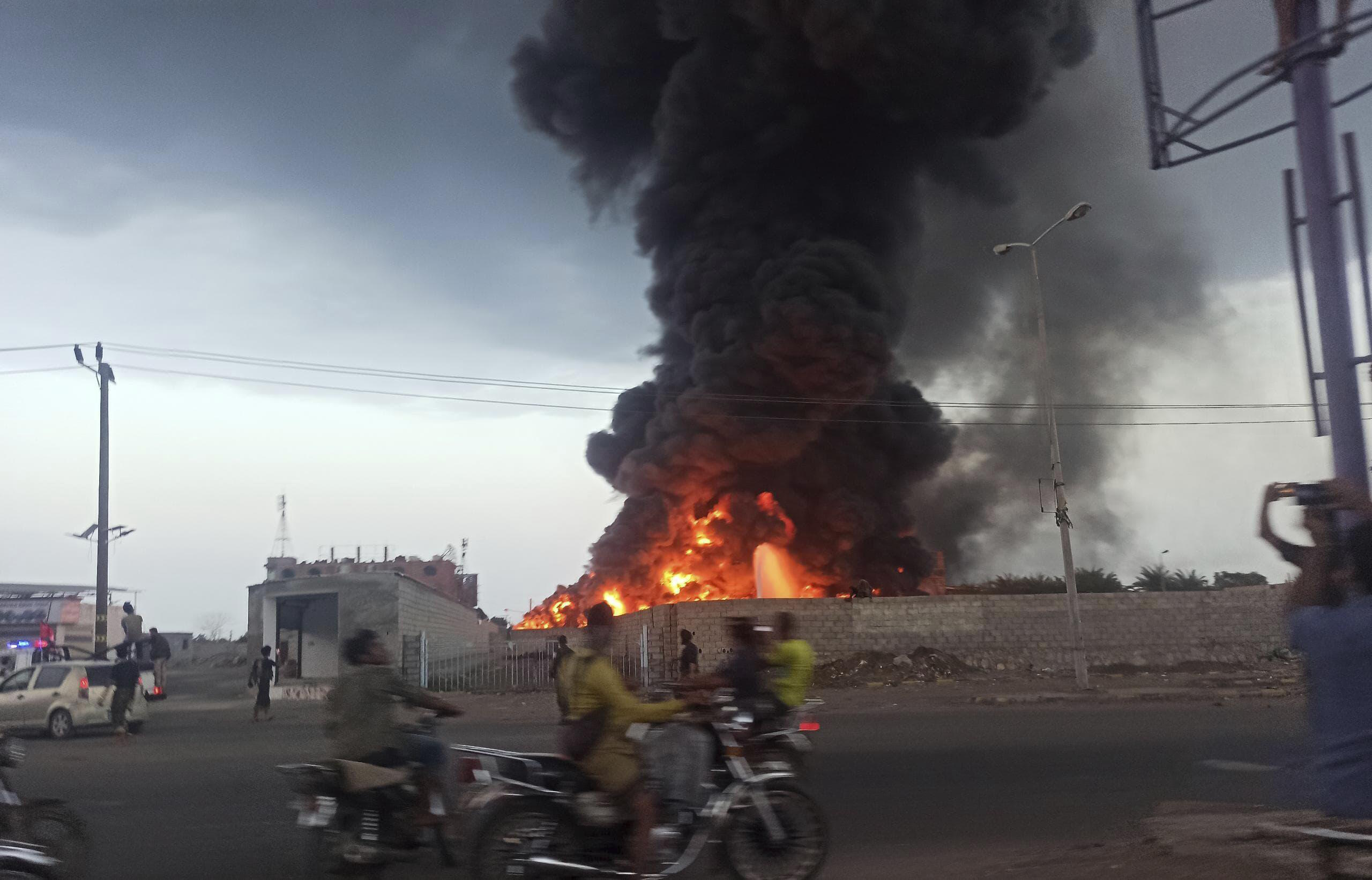 A large fire and plume of smoke is visible in the port city of Hodeida, Yemen.