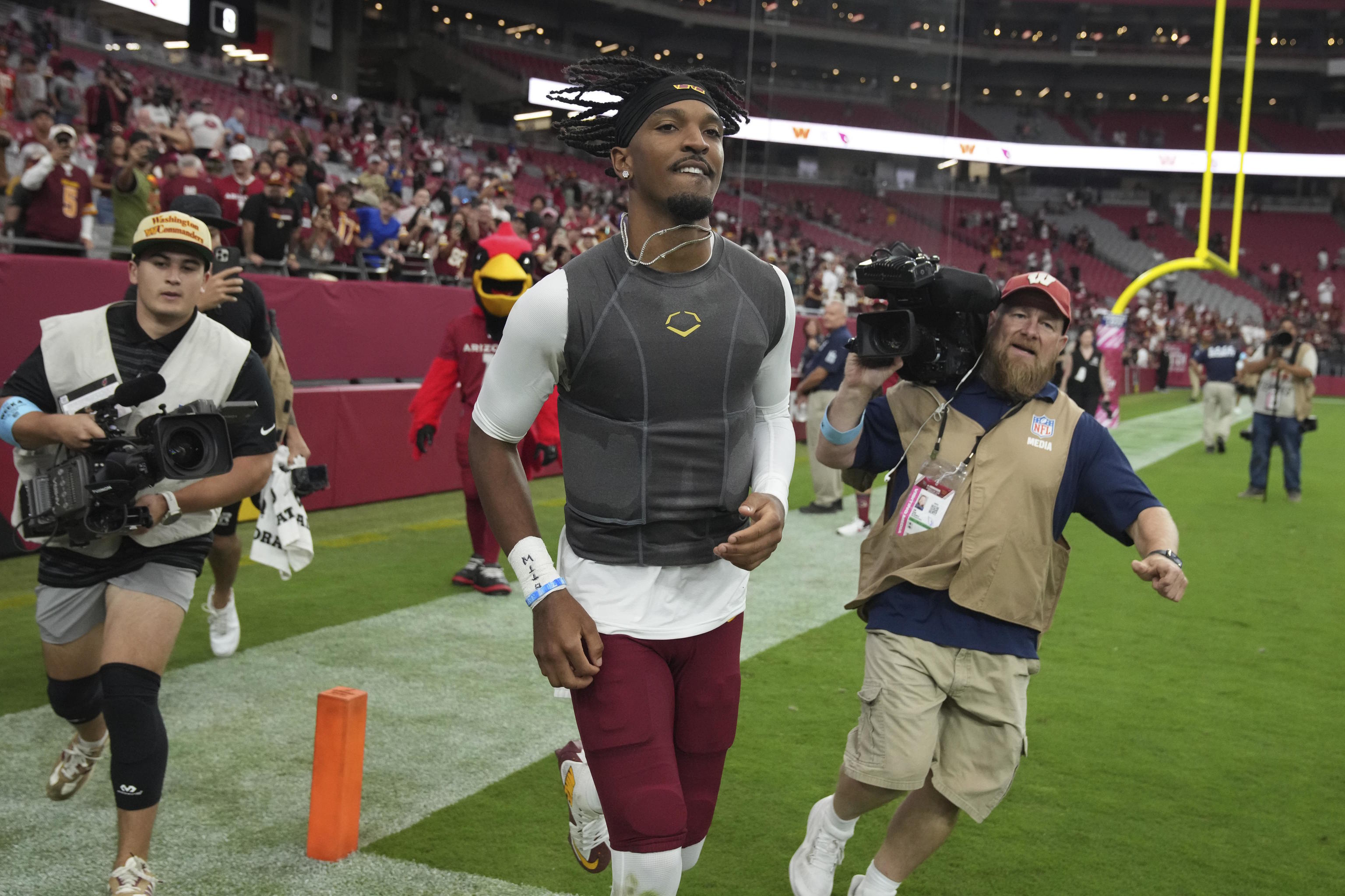 Washington Commanders quarterback Jayden Daniels leaves the field.