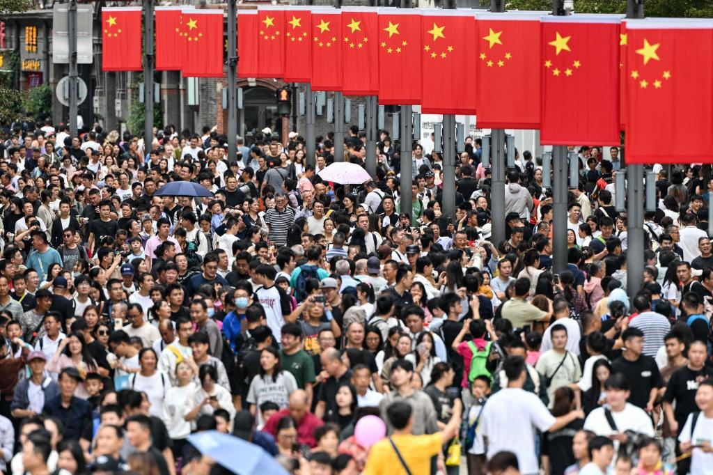 People walk along The Bund on China's National Day.