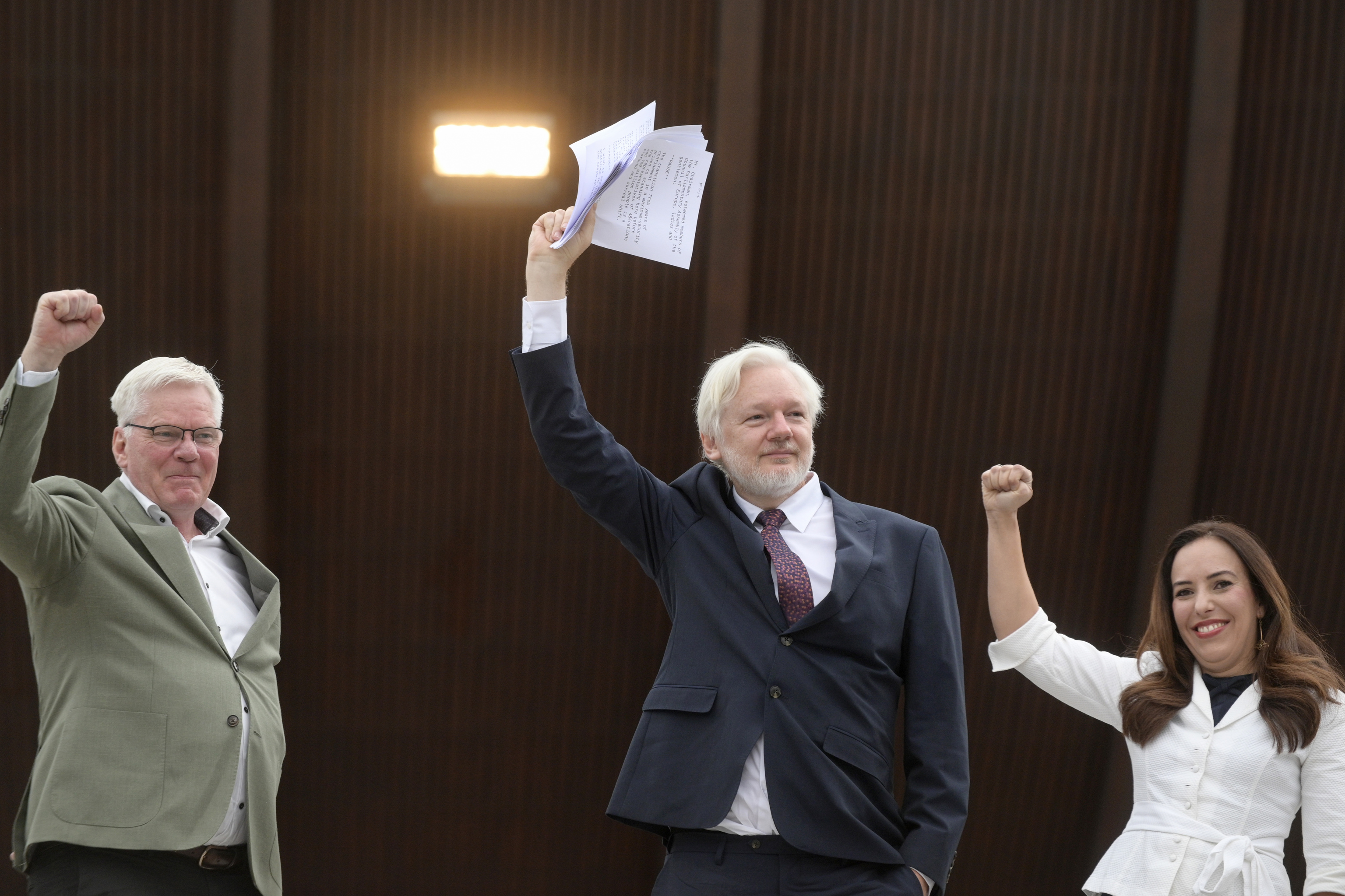 Wikileaks founder Julian Assange, center, his wife Stella Assange