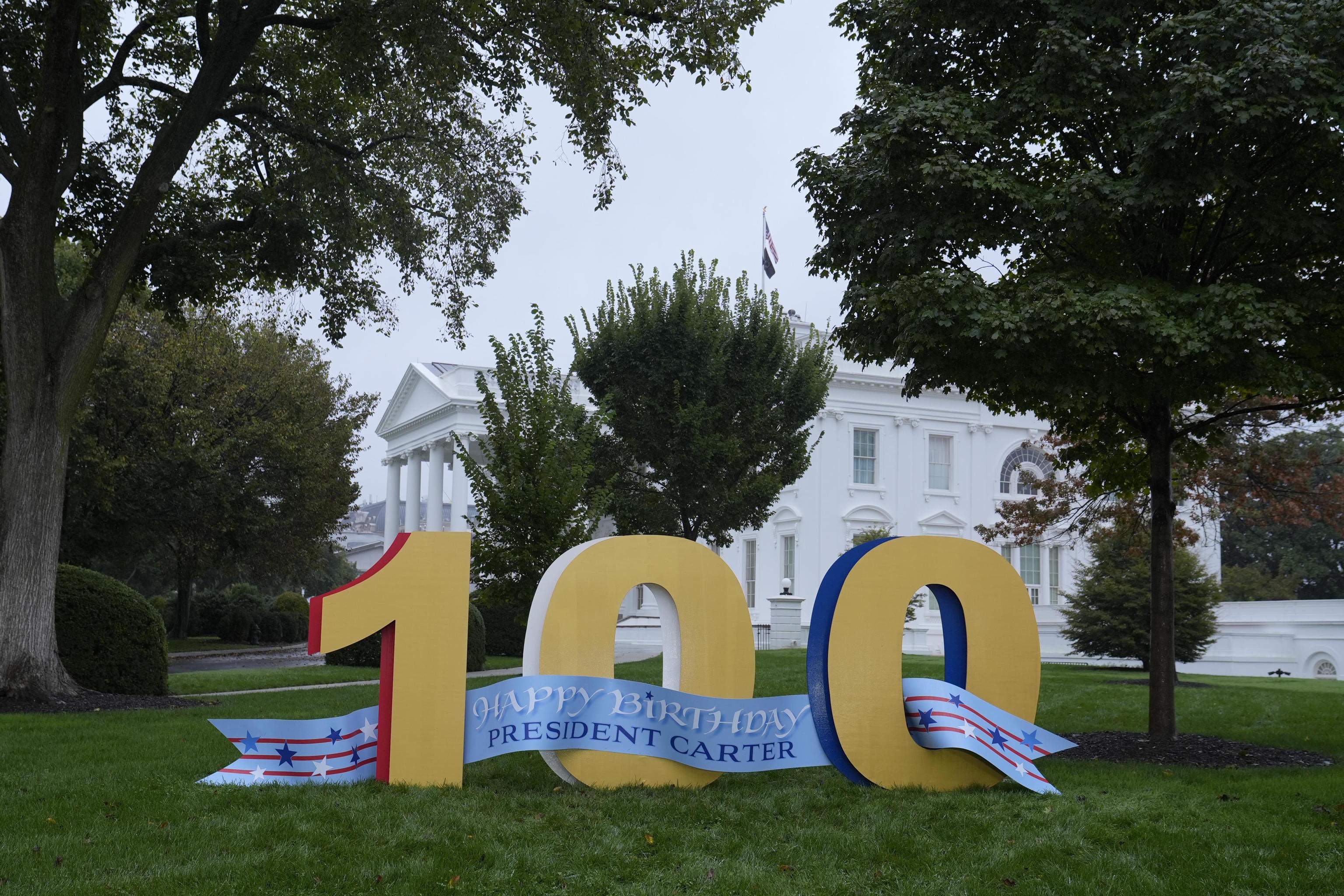 A sign wishing former President Jimmy Carter a happy 100th birthday.