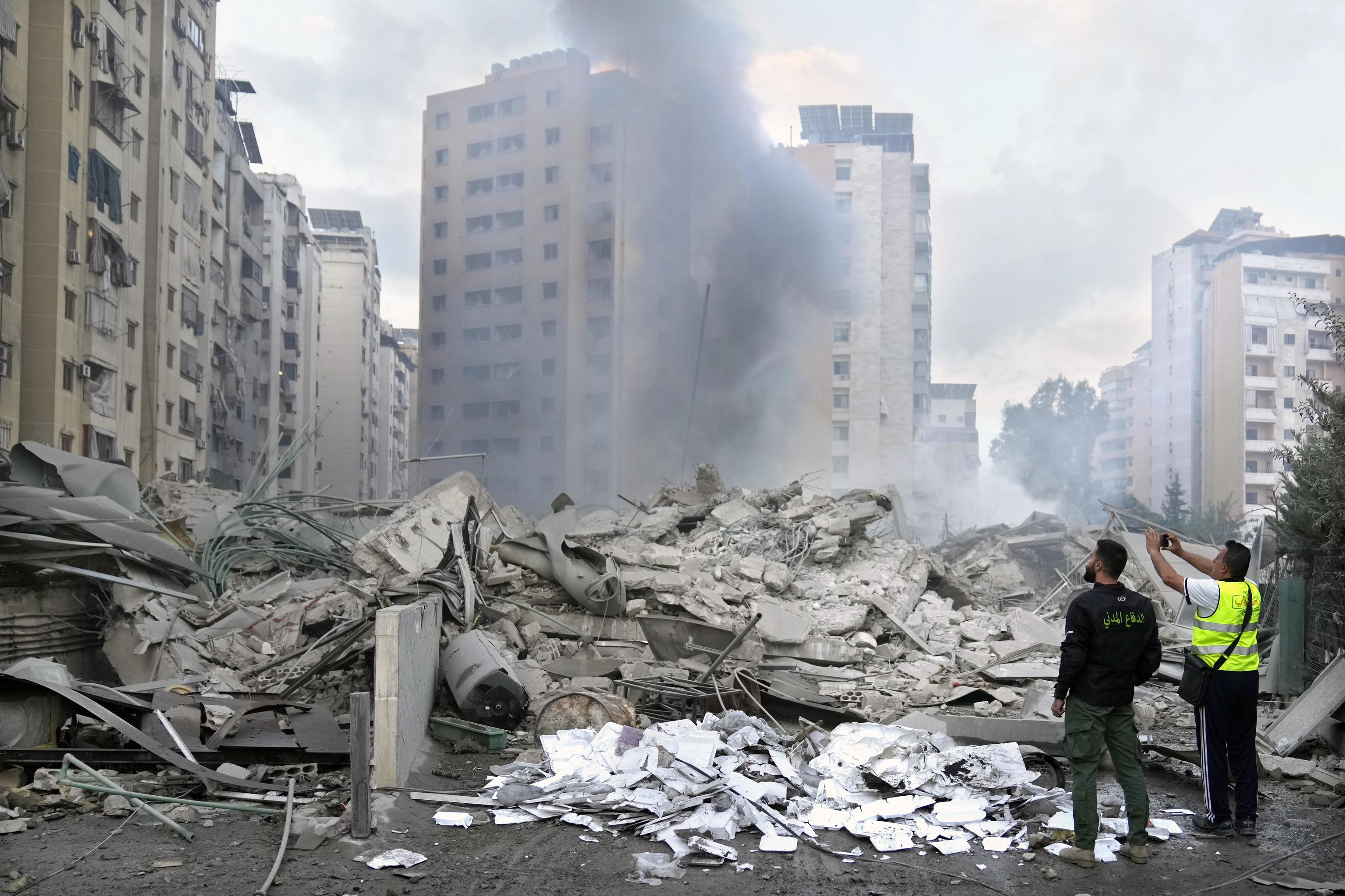 Civil Defense workers check a destroyed residential building in Beirut.