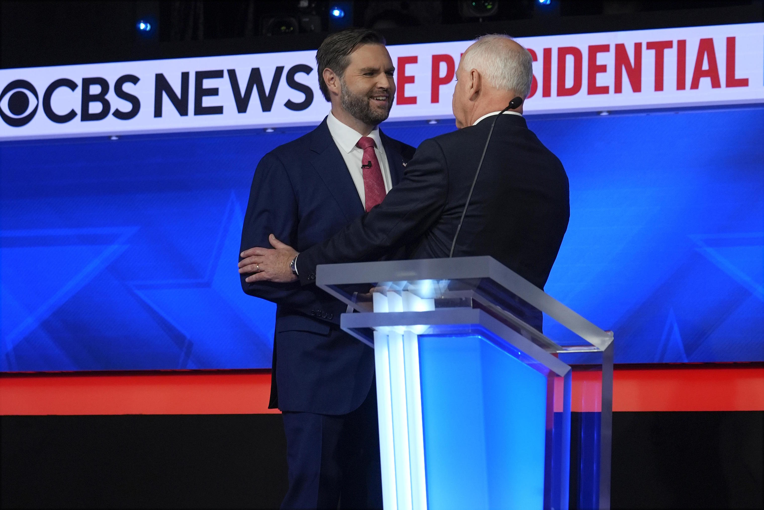 JD Vance, R-Ohio, shakes hands with Tim Walz.