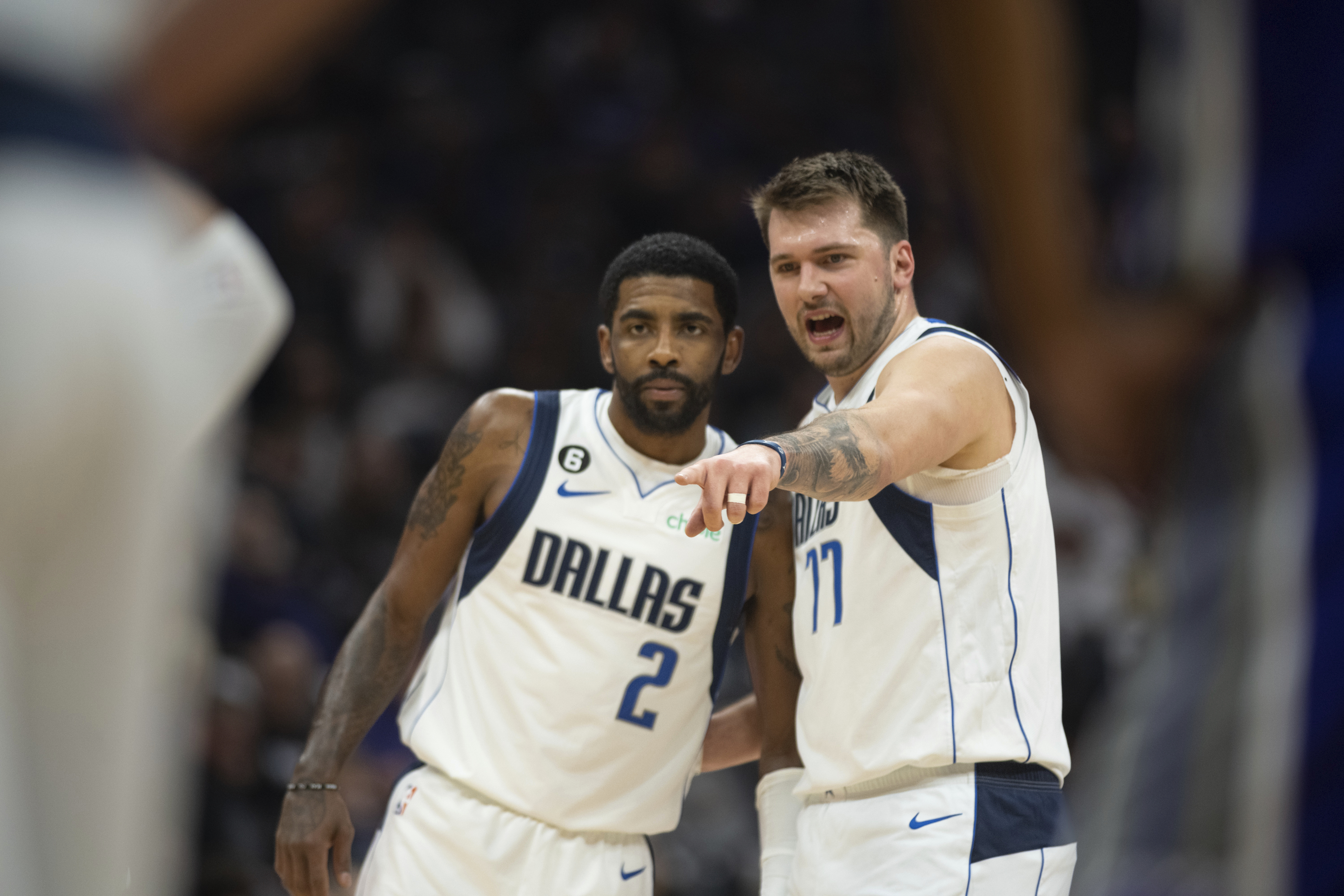 Dallas Mavericks guard Kyrie Irving (2) listens to guard Luka Doncic (77).