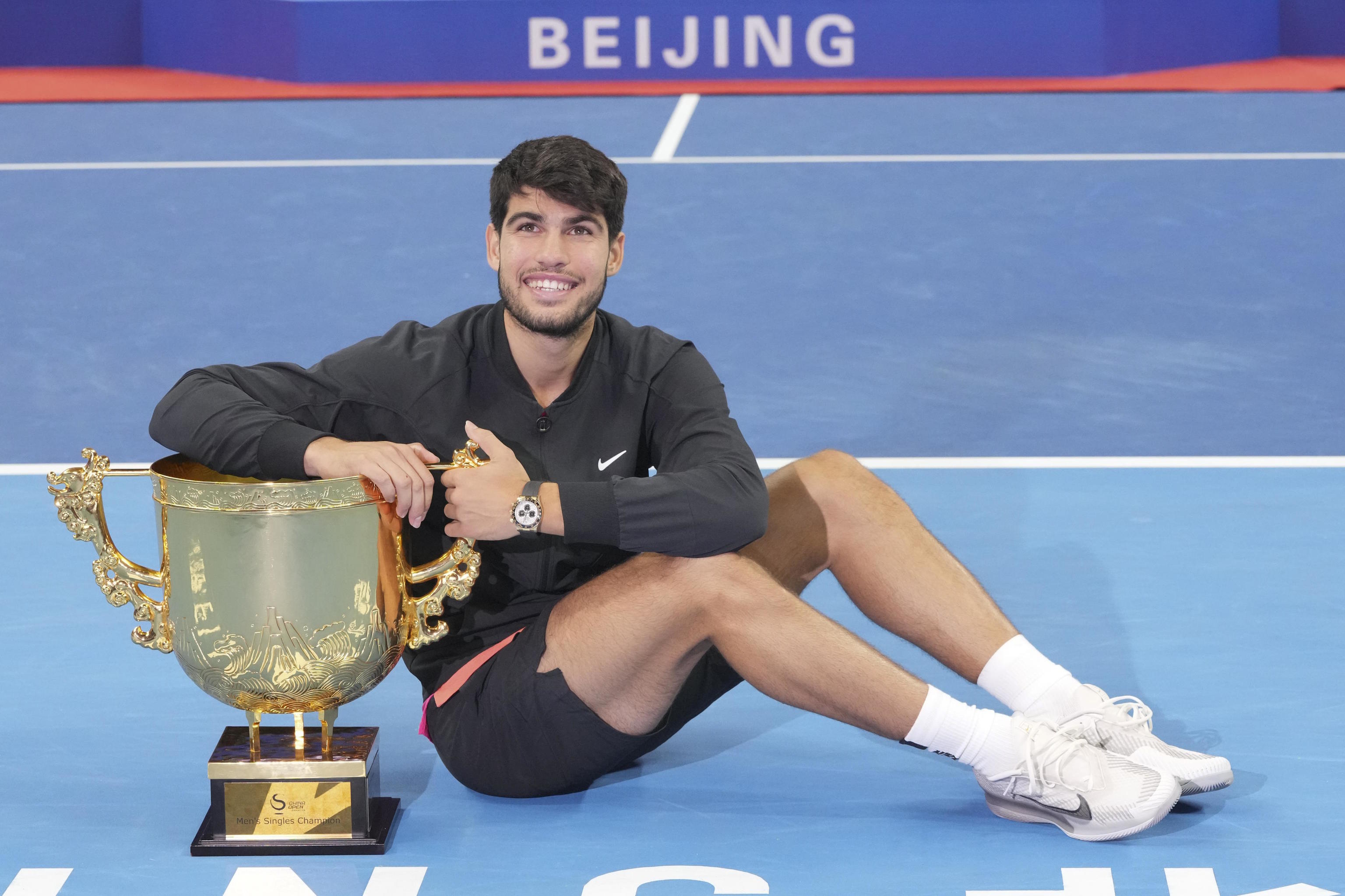 Carlos Alcaraz poses with the trophy as the winner of the ATP 500 in Beijing.