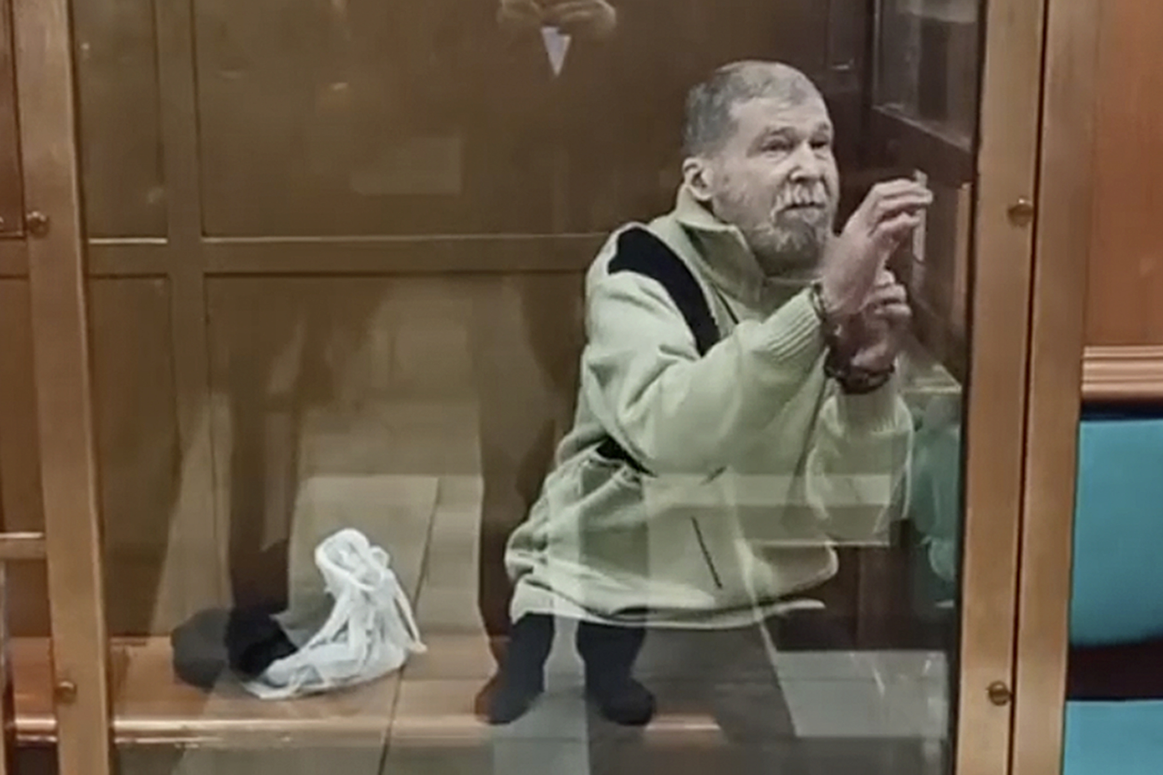 Stephen Hubbard, a U.S. citizen accused of fighting as a mercenary in Ukraine against Russia stands in a glass cage during a court session in the Moscow City court