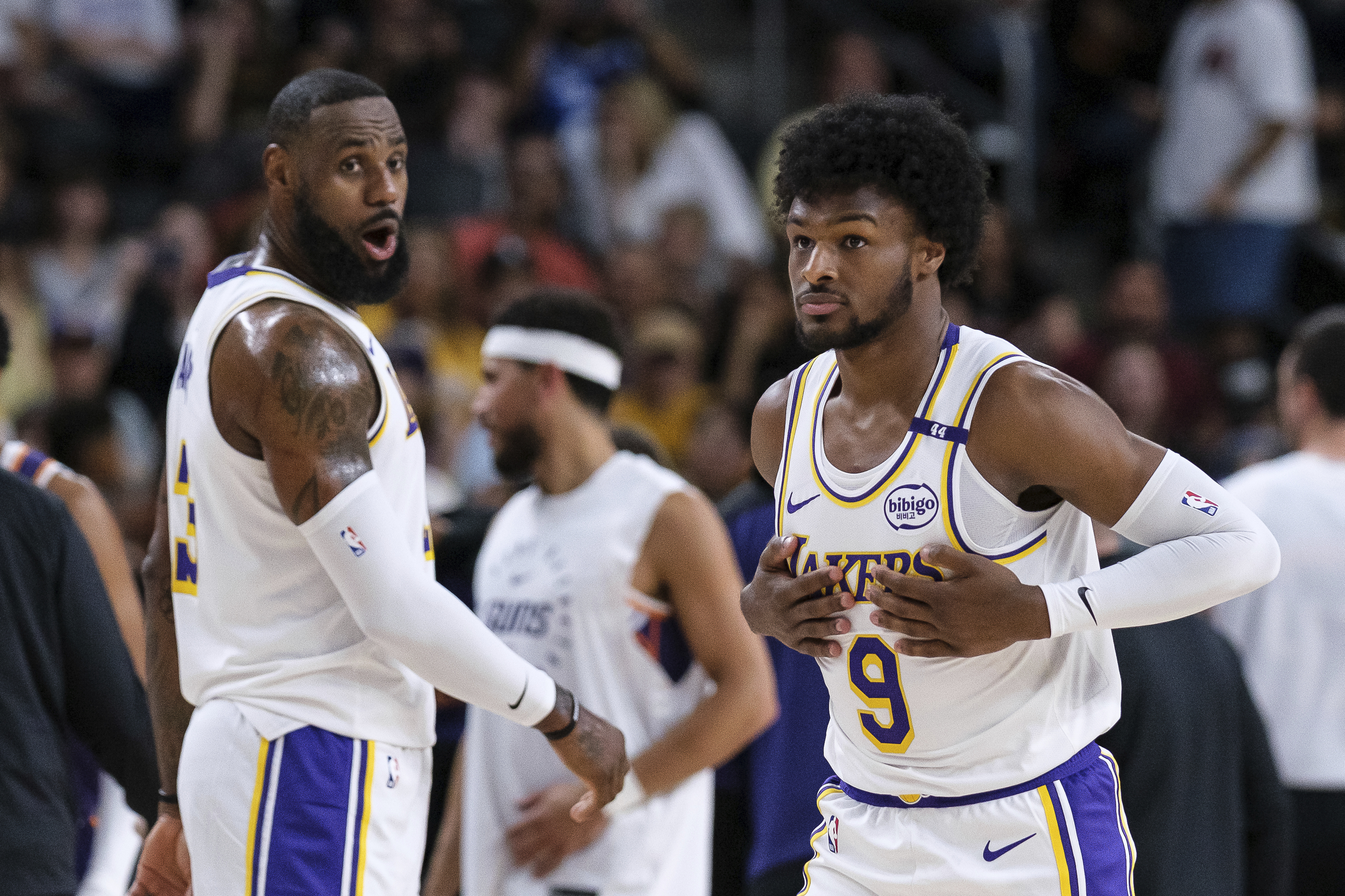 Los Angeles Lakers guard Bronny James (9), right, steps onto the court with Los Angeles Lakers forward LeBron James (23)