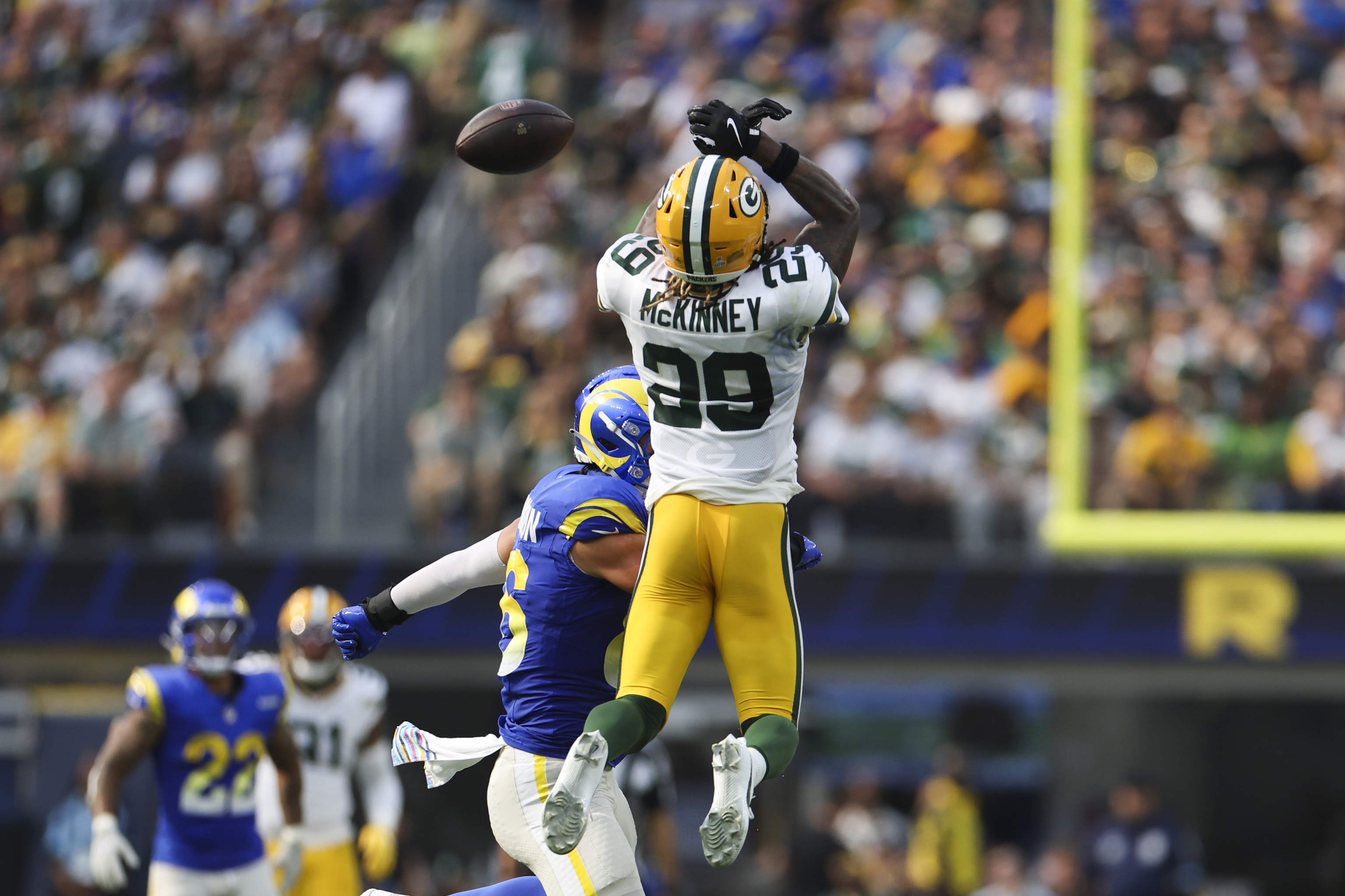 Green Bay Packers safety Xavier McKinney (29) attempts to intercept a pass.