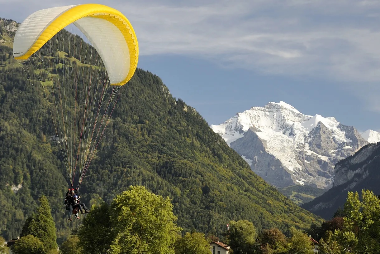 Paragliding is an exciting experience to fly over alpine landscapes.