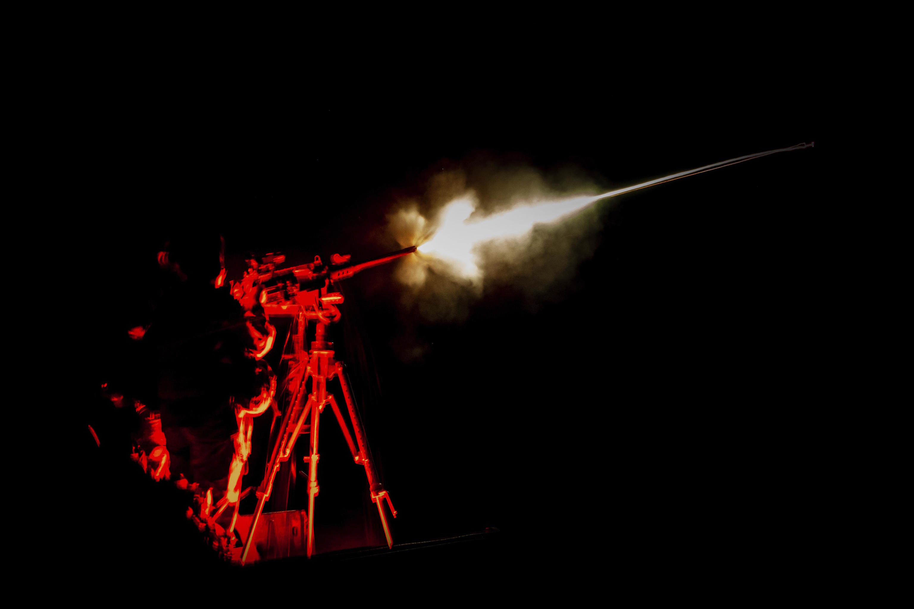 A Ukrainian serviceman fires by a machine gun in Kherson region.