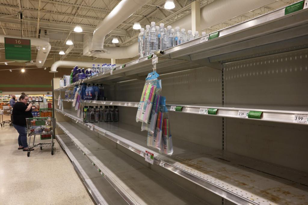 Shelves at a grocery store are empty of bottled water as Hurricane Milton.