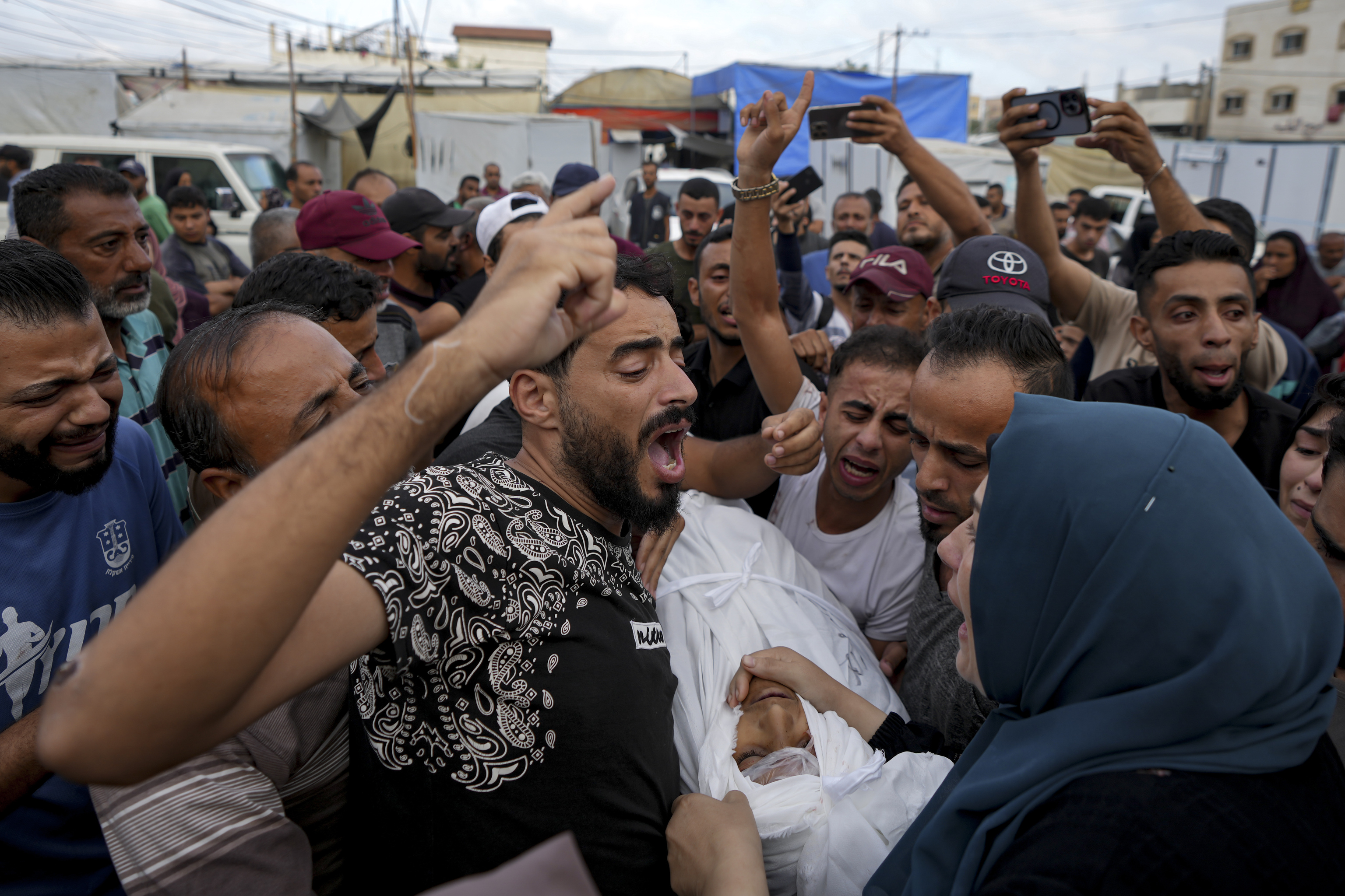 Palestinians mourn a relative killed in the Israeli bombardment of the Gaza.