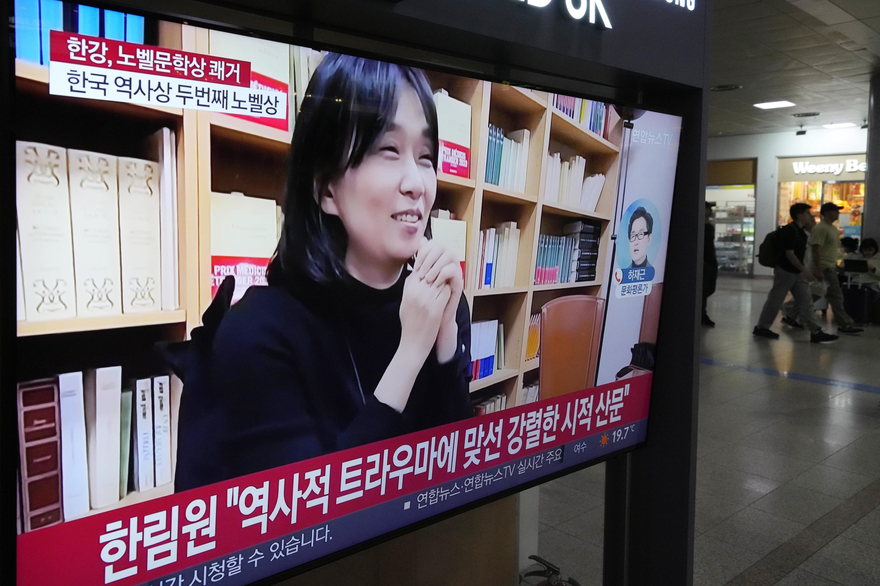 A TV screen shows an image of the winner of the 2024 Nobel in Literature.