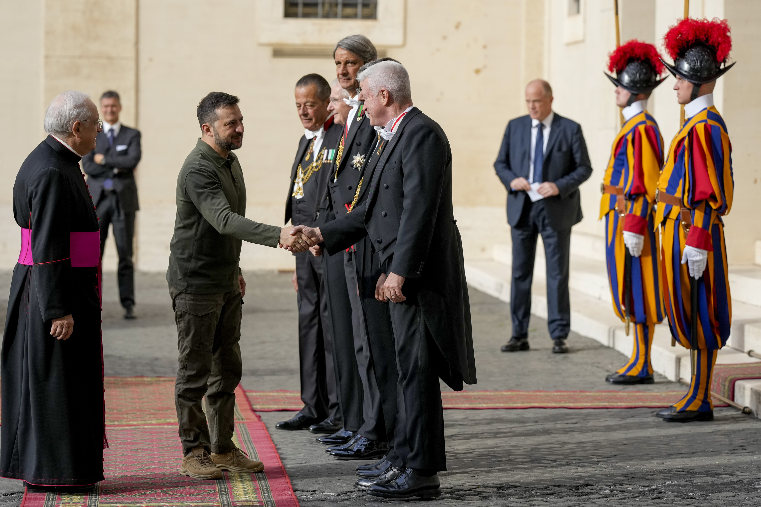 Ukraine's President Volodymyr Zelenskyy, second from left, arrives in the St. Damasus courtyard at the Vatican