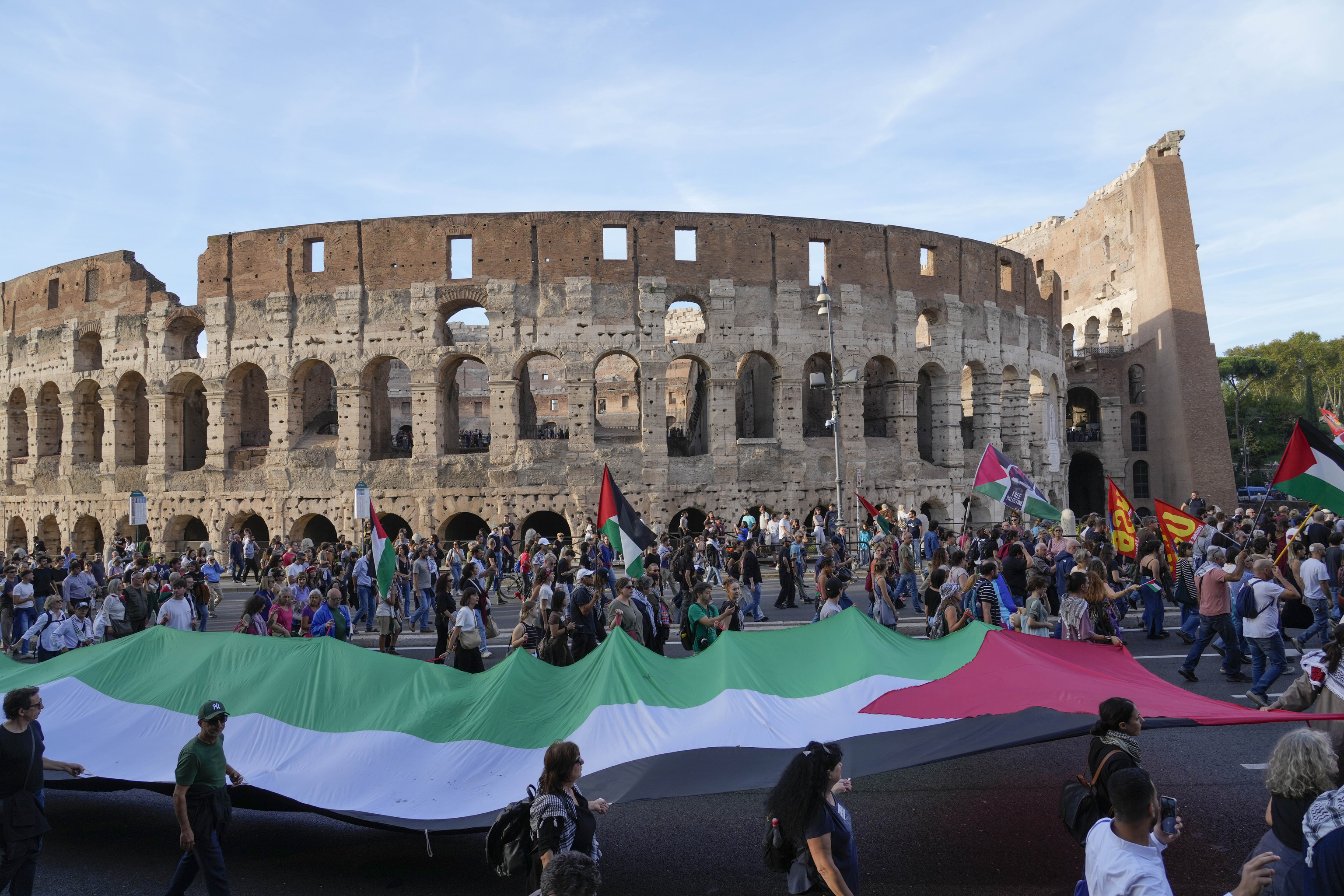 People walk past the Colosseum during a pro-Palestinian rally in Rome