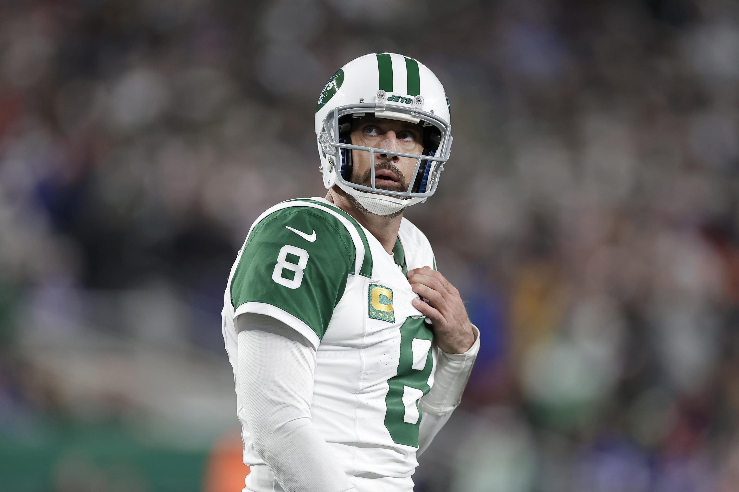 New York Jets quarterback Aaron Rodgers walks on the field during the second half of an NFL football game.