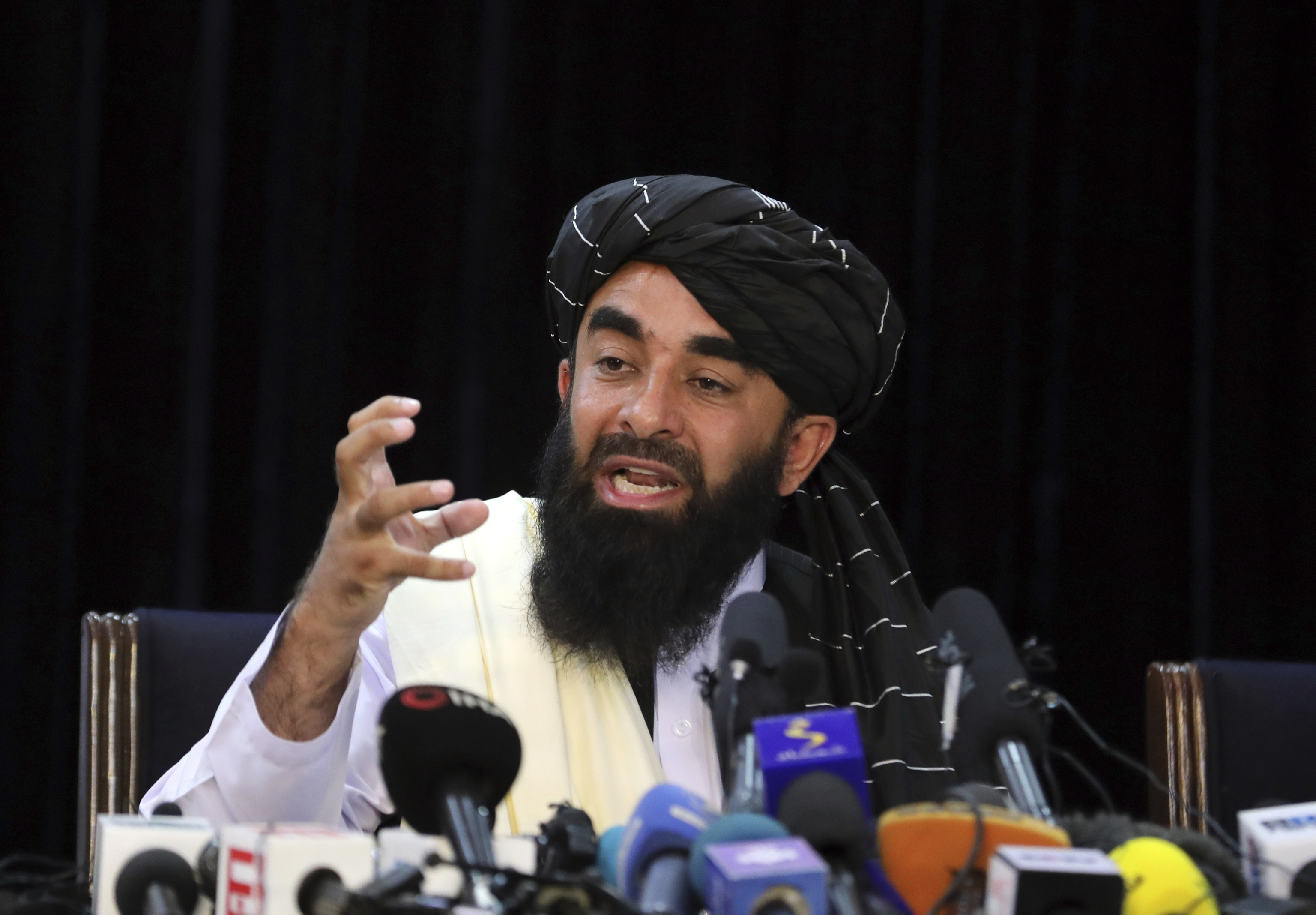 Taliban spokesman Zabihullah Mujahid speaks at his first news conference