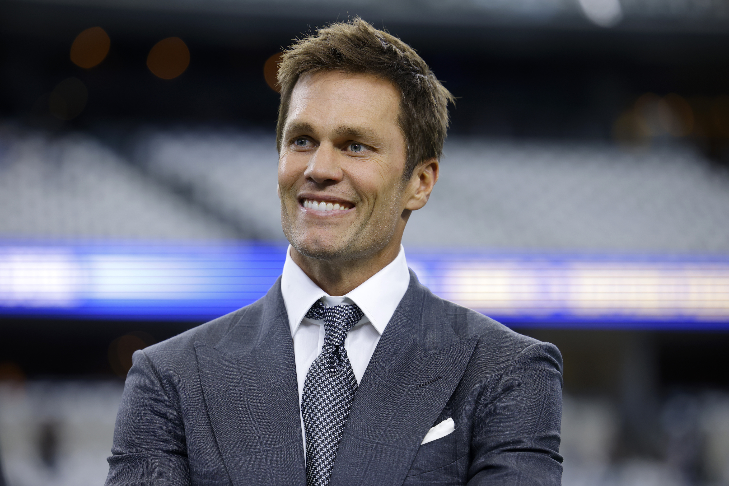 Fox Sports lead NFL analyst Tom Brady stands on the field during warmups before an NFL football game.