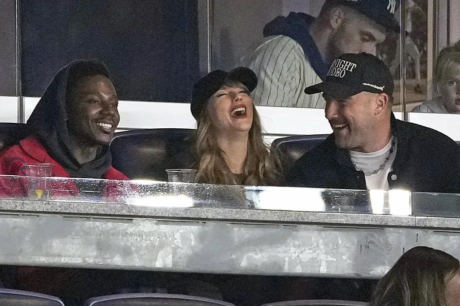 Taylor Swift, her partner, Travis Kelce, and actor Jerrod Carmichael.