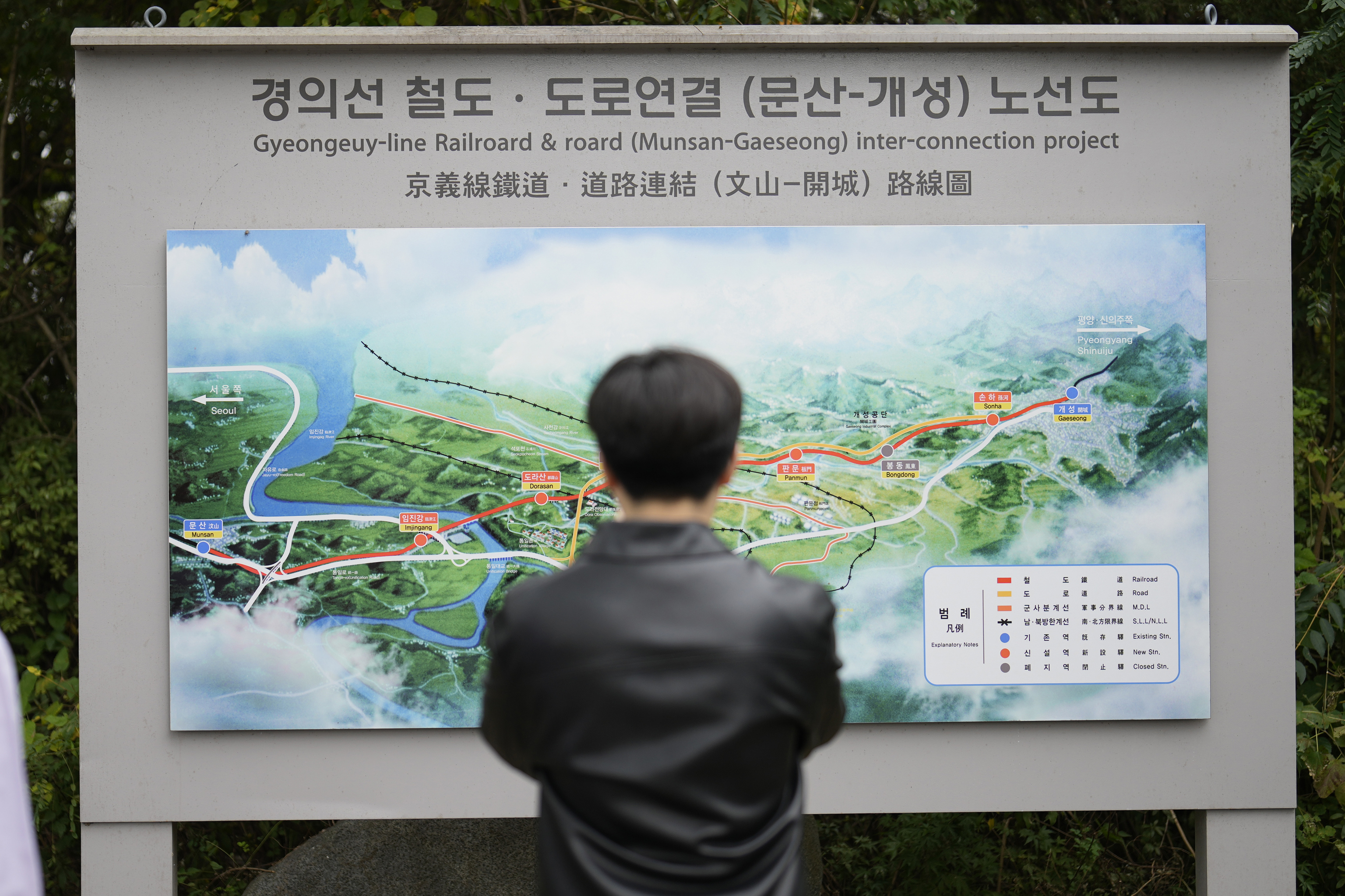 A visitor looks at a map of railroad and road between two Koreas cities