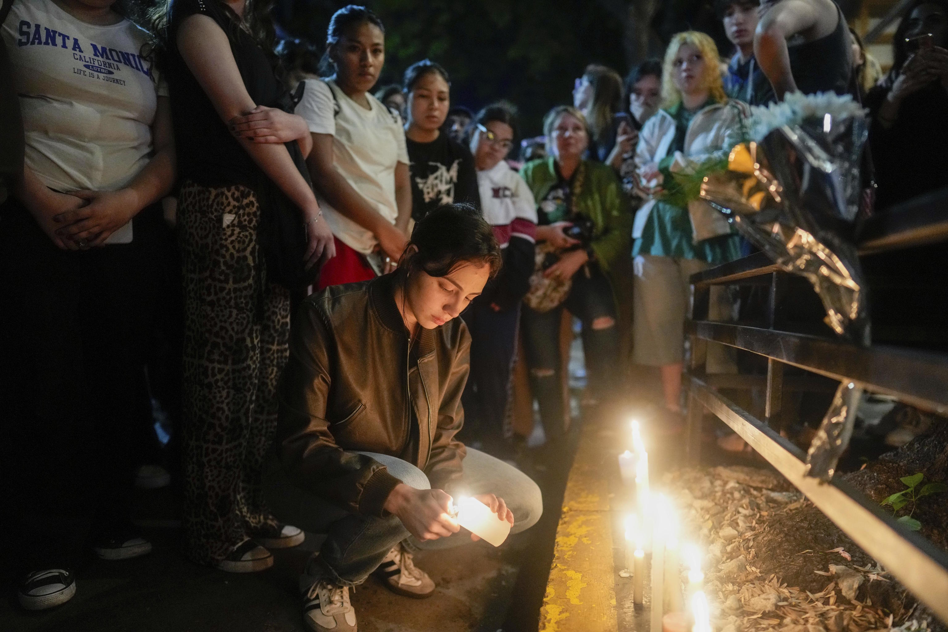 Fans light candles outside the hotel where Liam Payne was found dead.