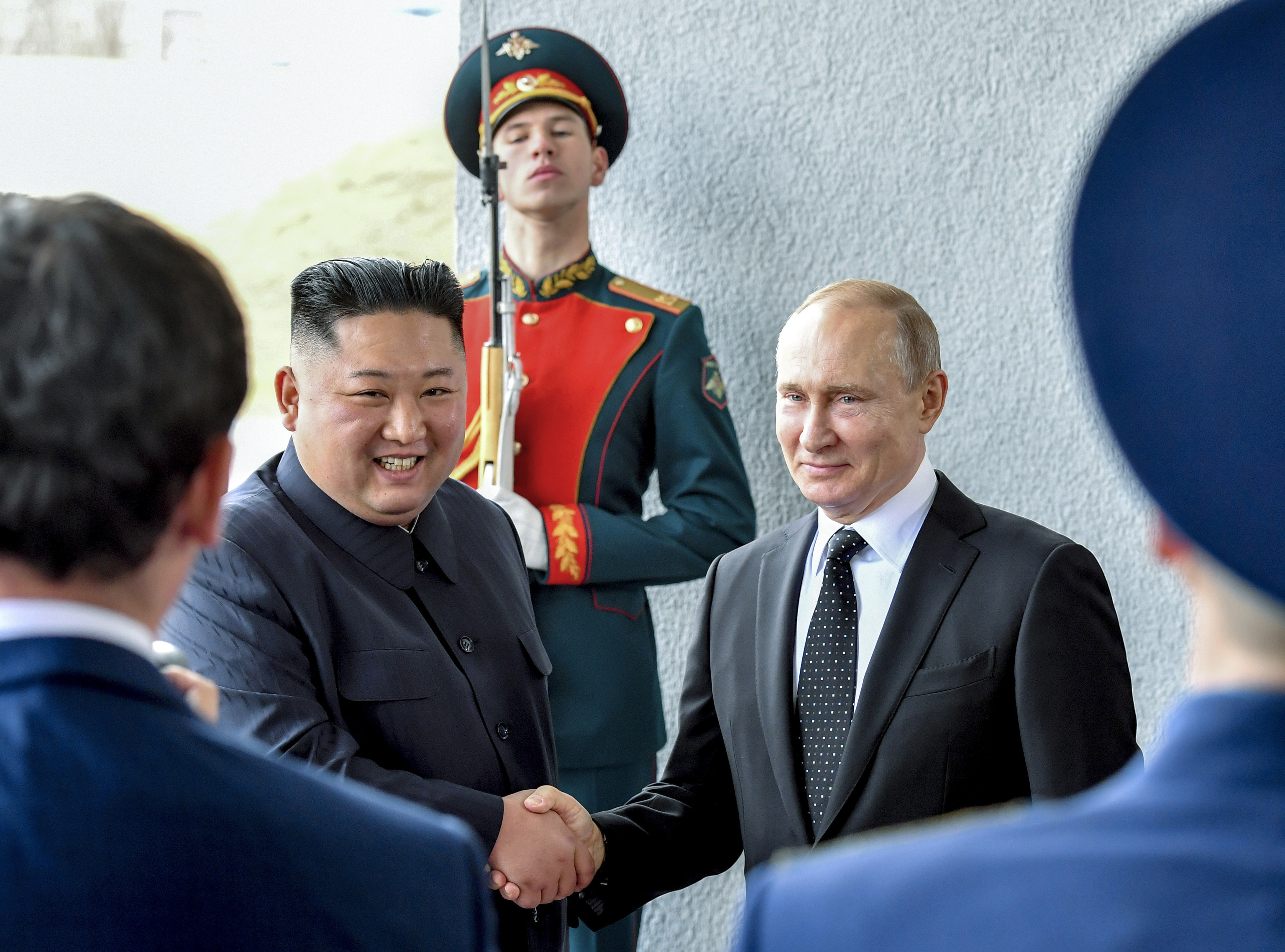 Russian President Vladimir Putin, right, and North Korea's leader Kim Jong Un shake hands