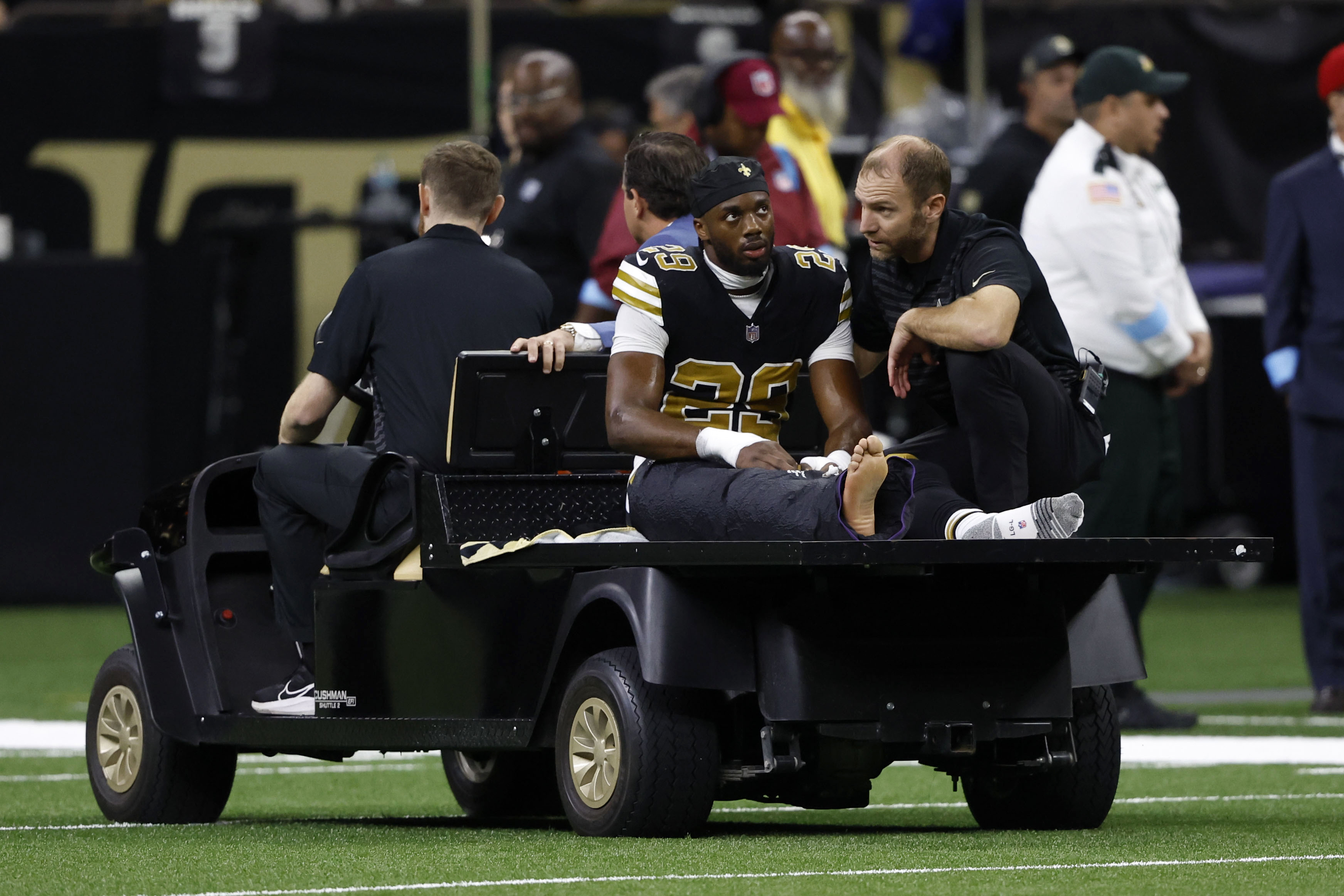 New Orleans Saints cornerback Paulson Adebo (29) is carted off the field after getting injured