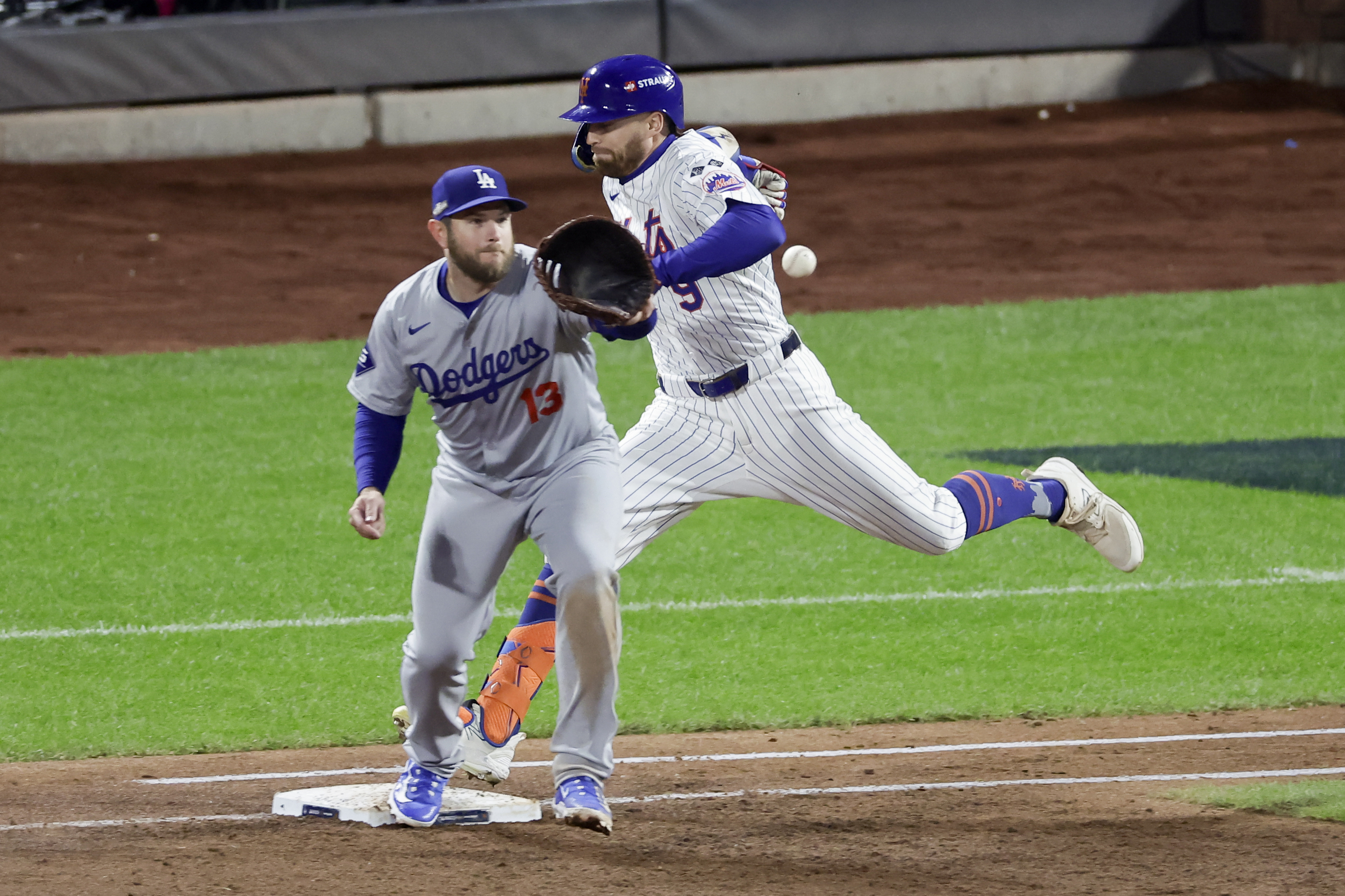 New York Mets' Brandon Nimmo is safe at first past Los Angeles Dodgers first baseman Max Muncy