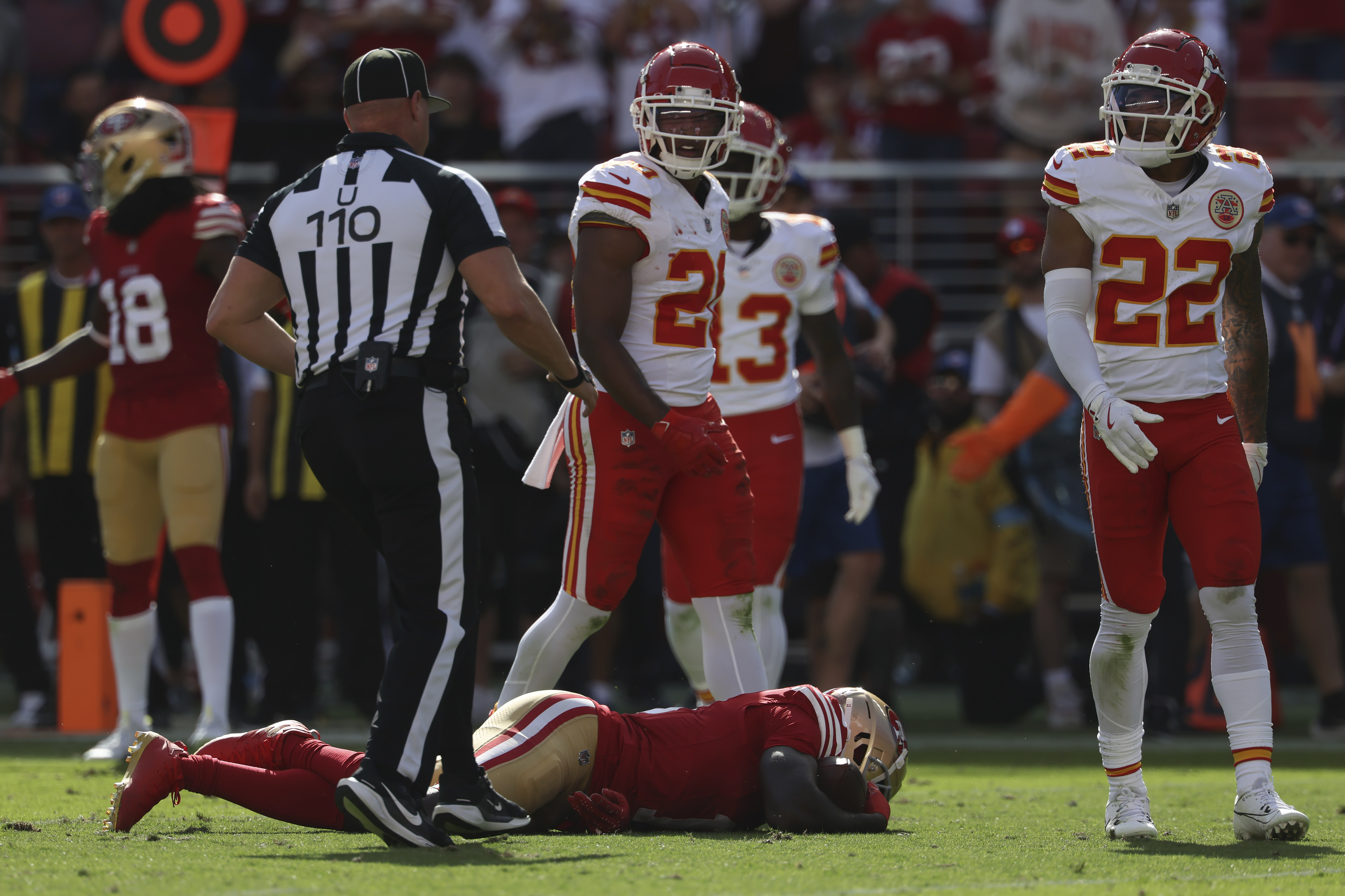 San Francisco 49ers wide receiver Brandon Aiyuk, bottom, remains on the field after being hit during the first half.