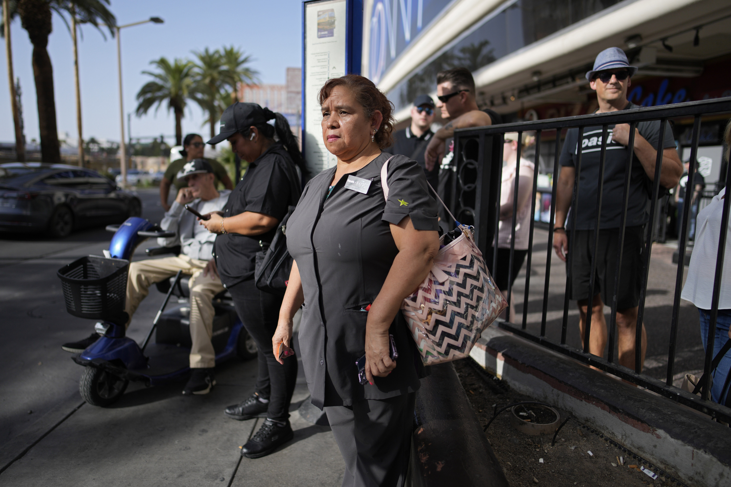 Haydee Zetino waits for the bus after working a shift as a maid at Harrah's hotel-casino along the Las Vegas Stri