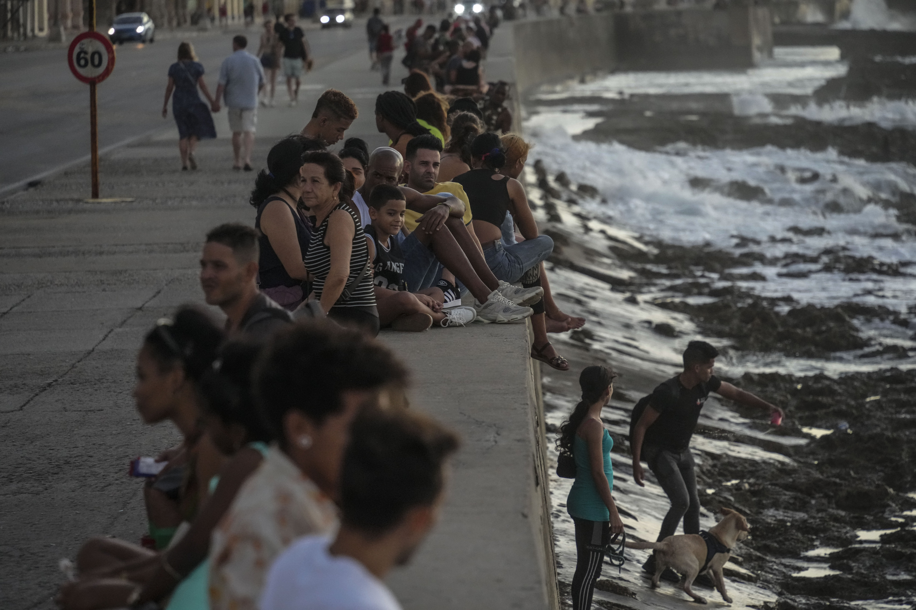 Residents pass the time at the malecon during a blackout following the failure of a major power plant in Havana