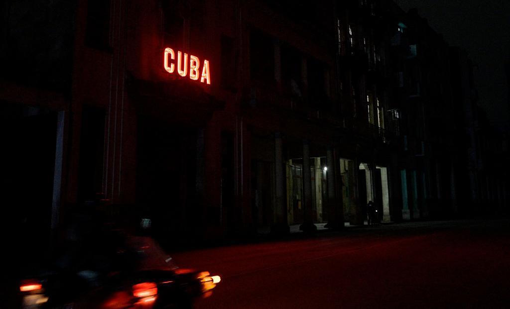 A sign lits a blacked out street in Havana.