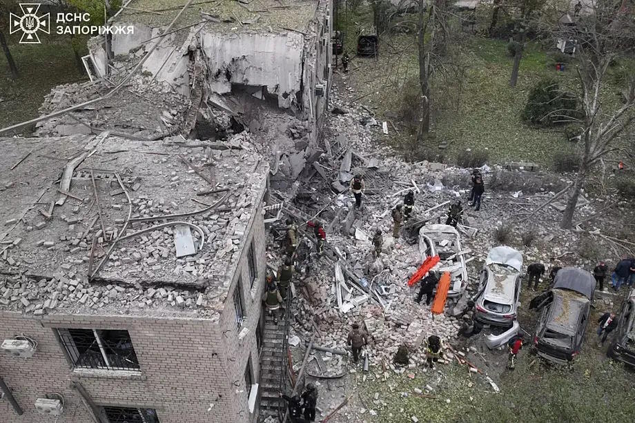 Ukrainian emergency services work on a building in Zaporizhia.