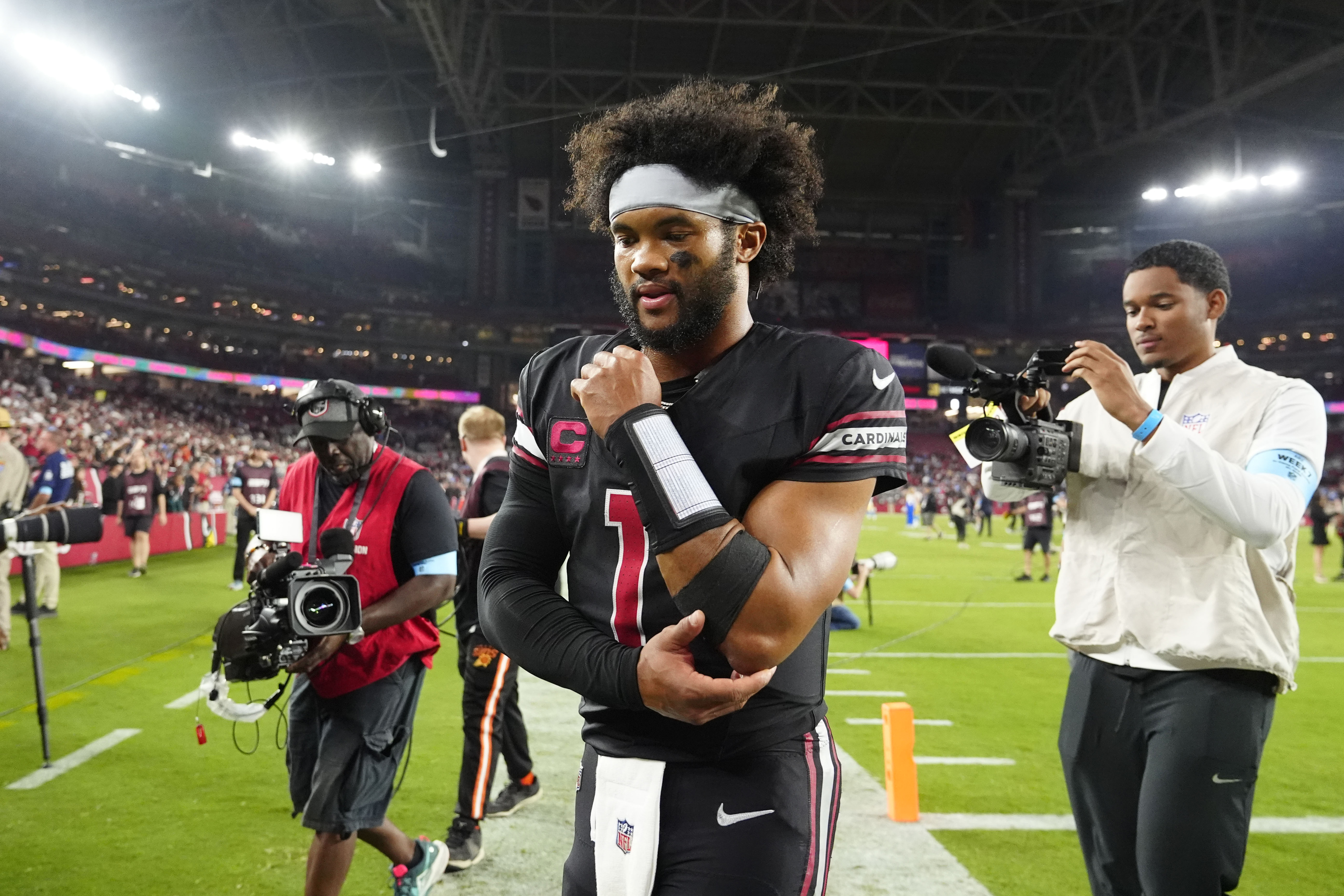 Arizona Cardinals quarterback Kyler Murray walks off the field after an NFL football game.