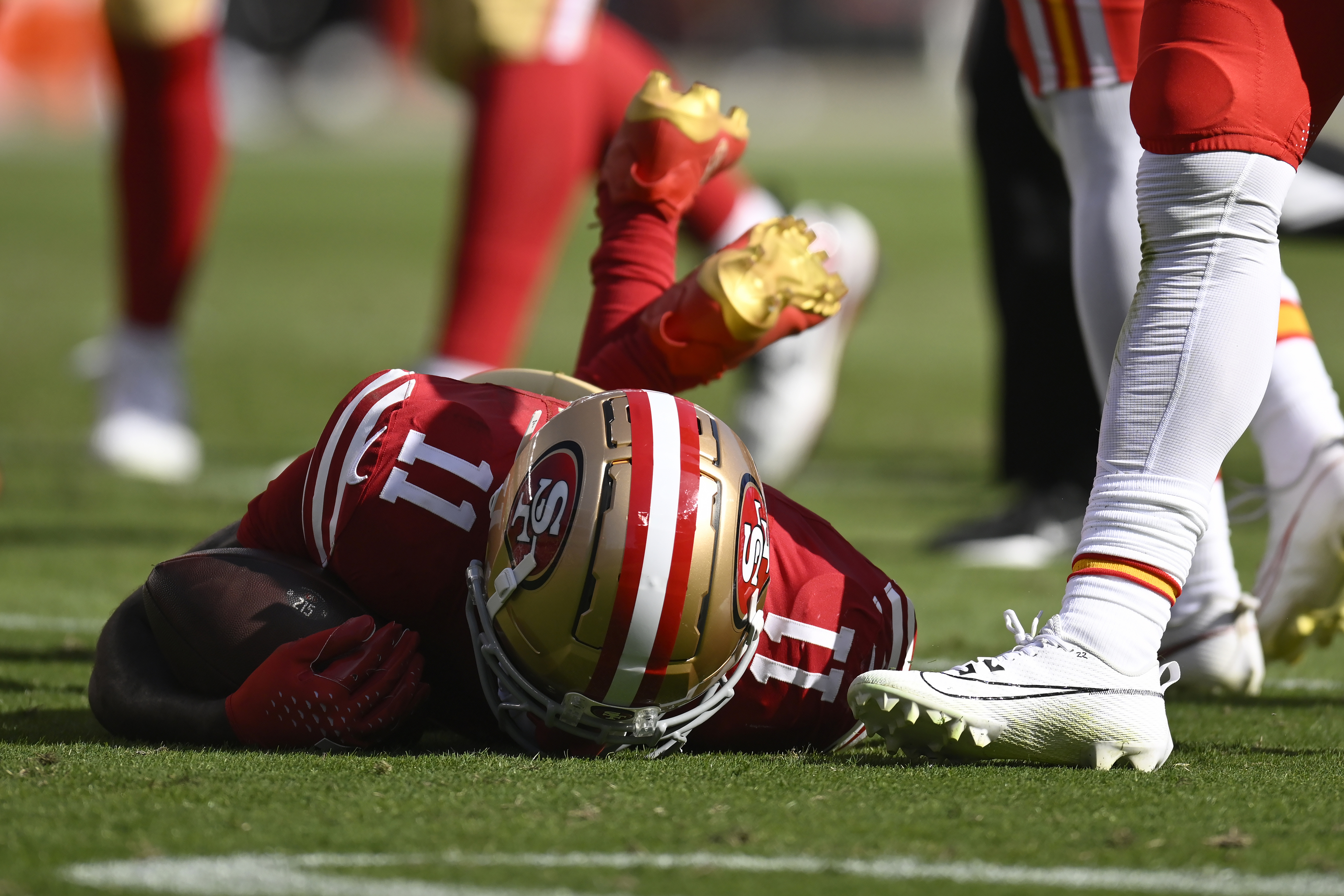 San Francisco 49ers wide receiver Brandon Aiyuk (11) remains on the field after being hit.