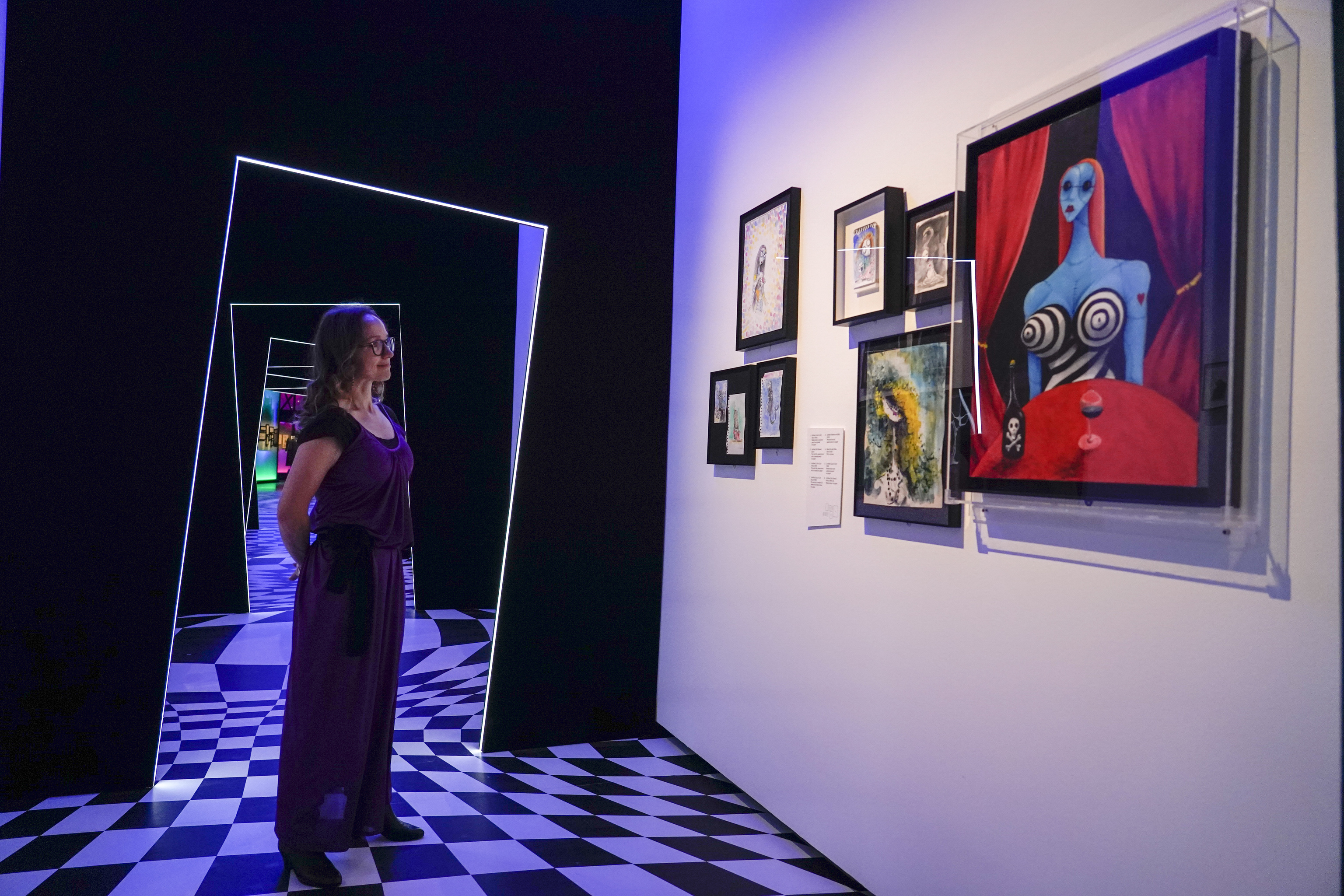 A member of staff poses at The World of Tim Burton exhibition at the Design Museum, in London