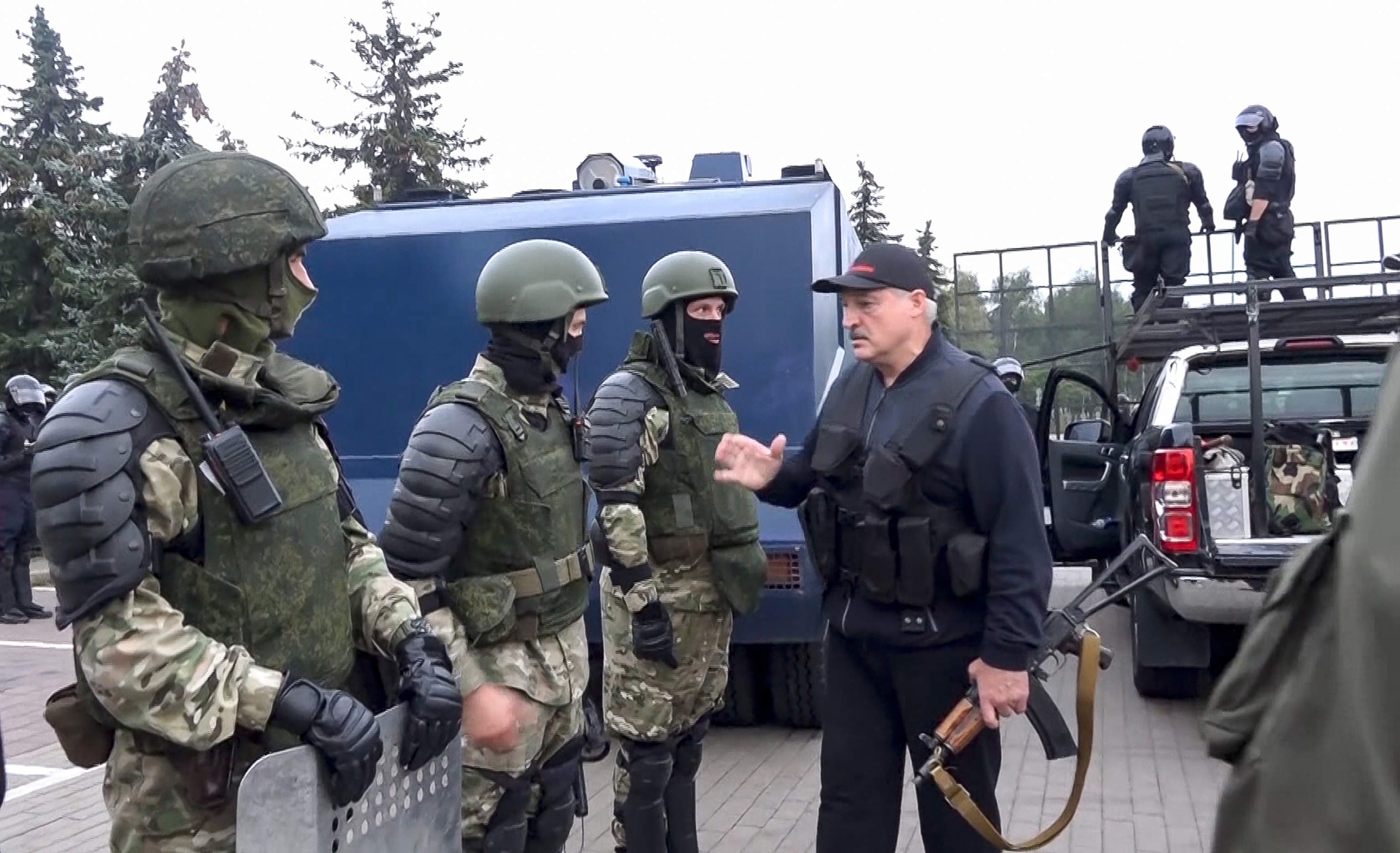 President Alexander Lukashenko greets riot police near the Palace of Independence in Minsk, Belarus, amid street protests