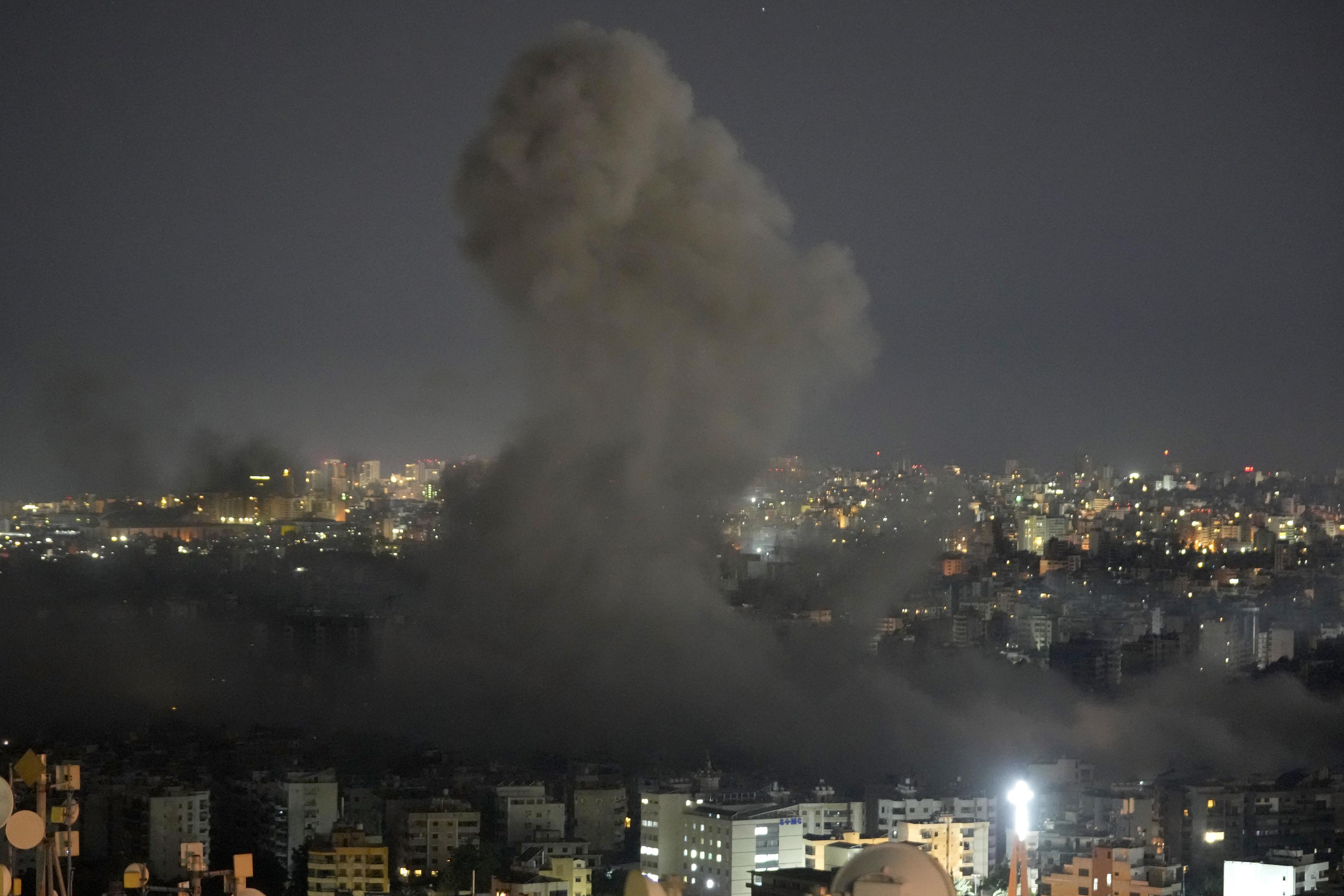 A large column of smoke rises over southern Beirut.