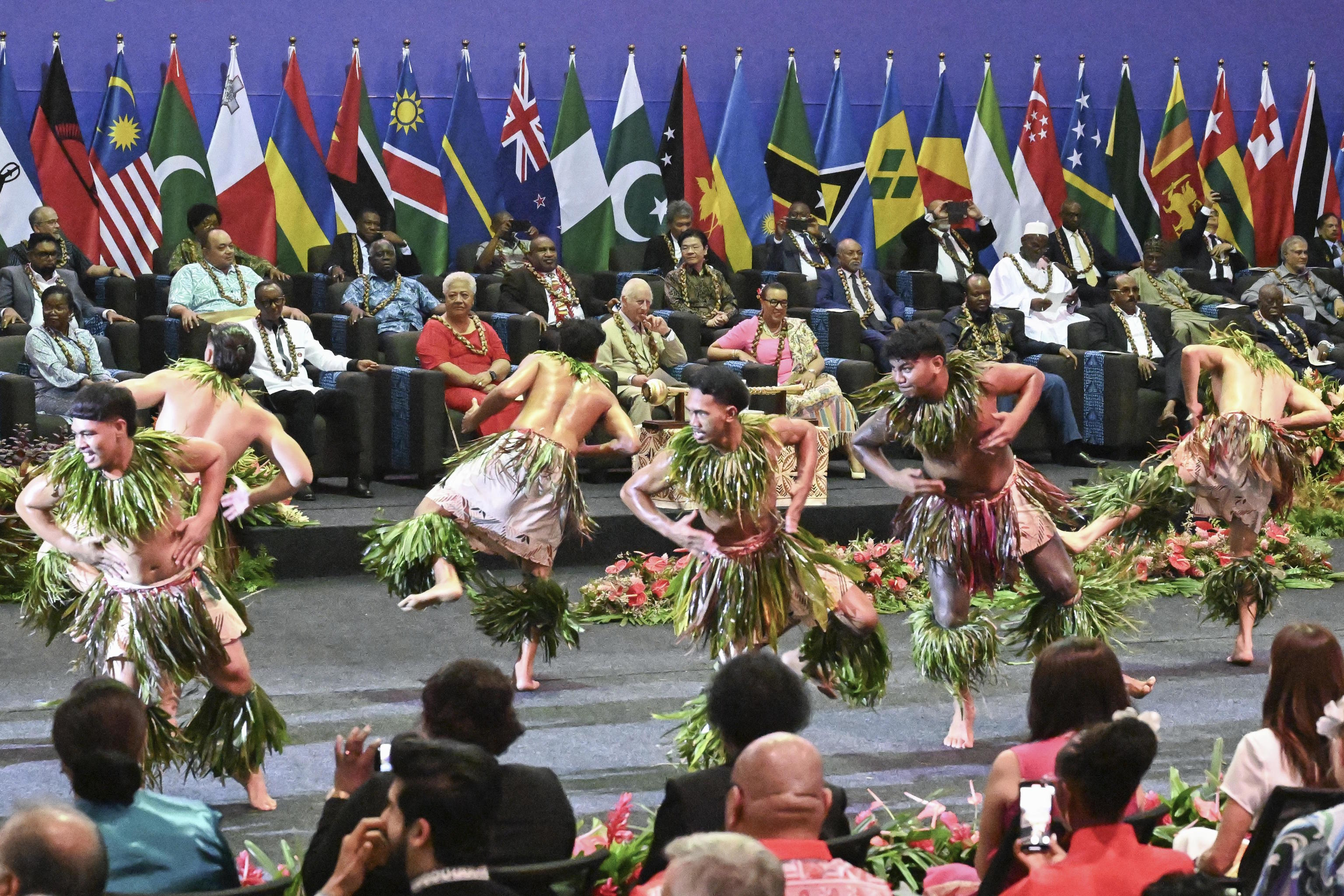 King Charles III watches as dancers perform during the opening ceremony.