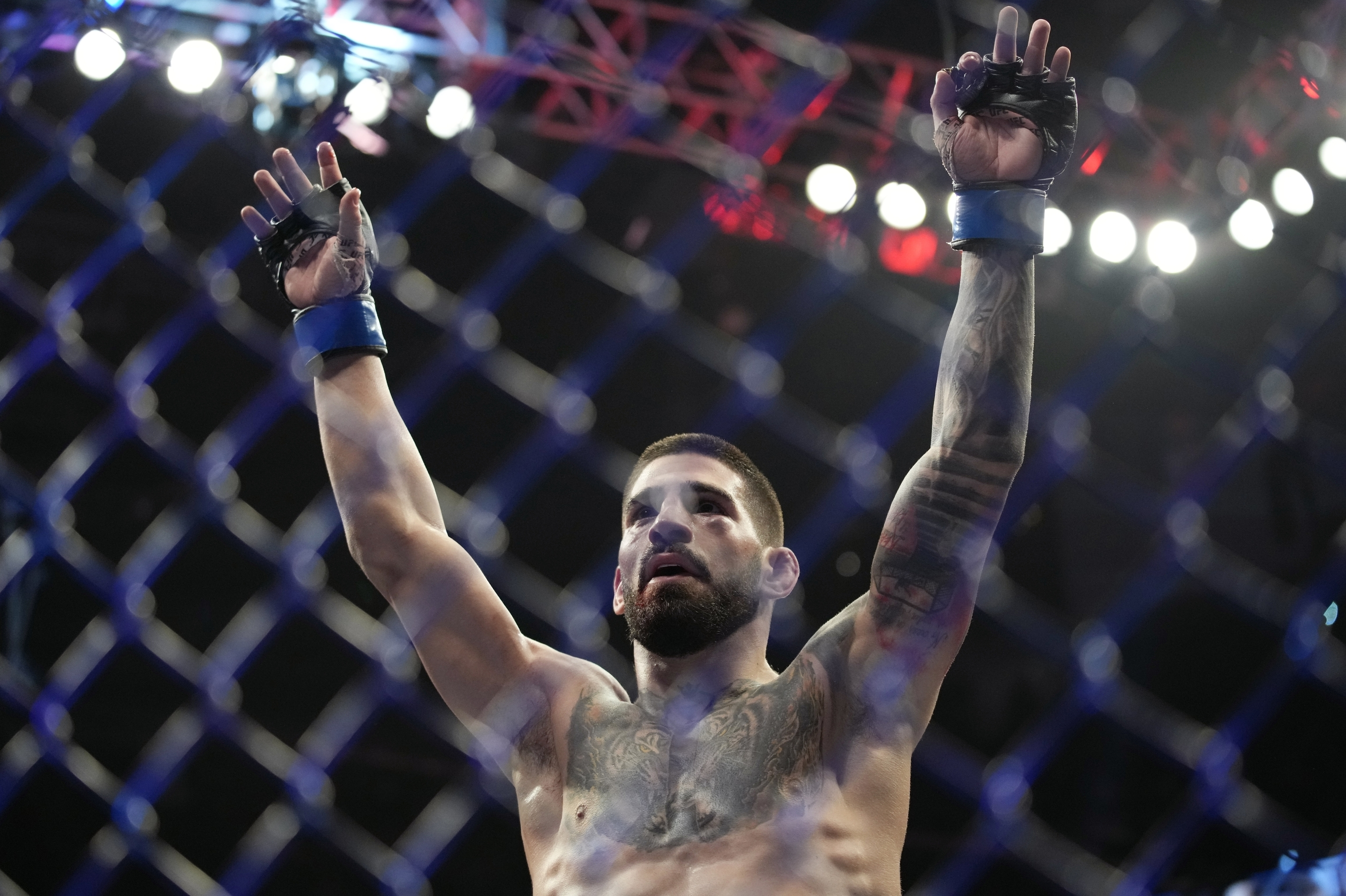 Ilia Topuria celebrates after defeating Bryce Mitchell in a UFC 282 mixed martial arts featherweight bout