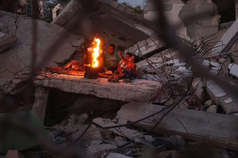 A Palestinian family warms up in the Palestinian refugee camp of Bureij.