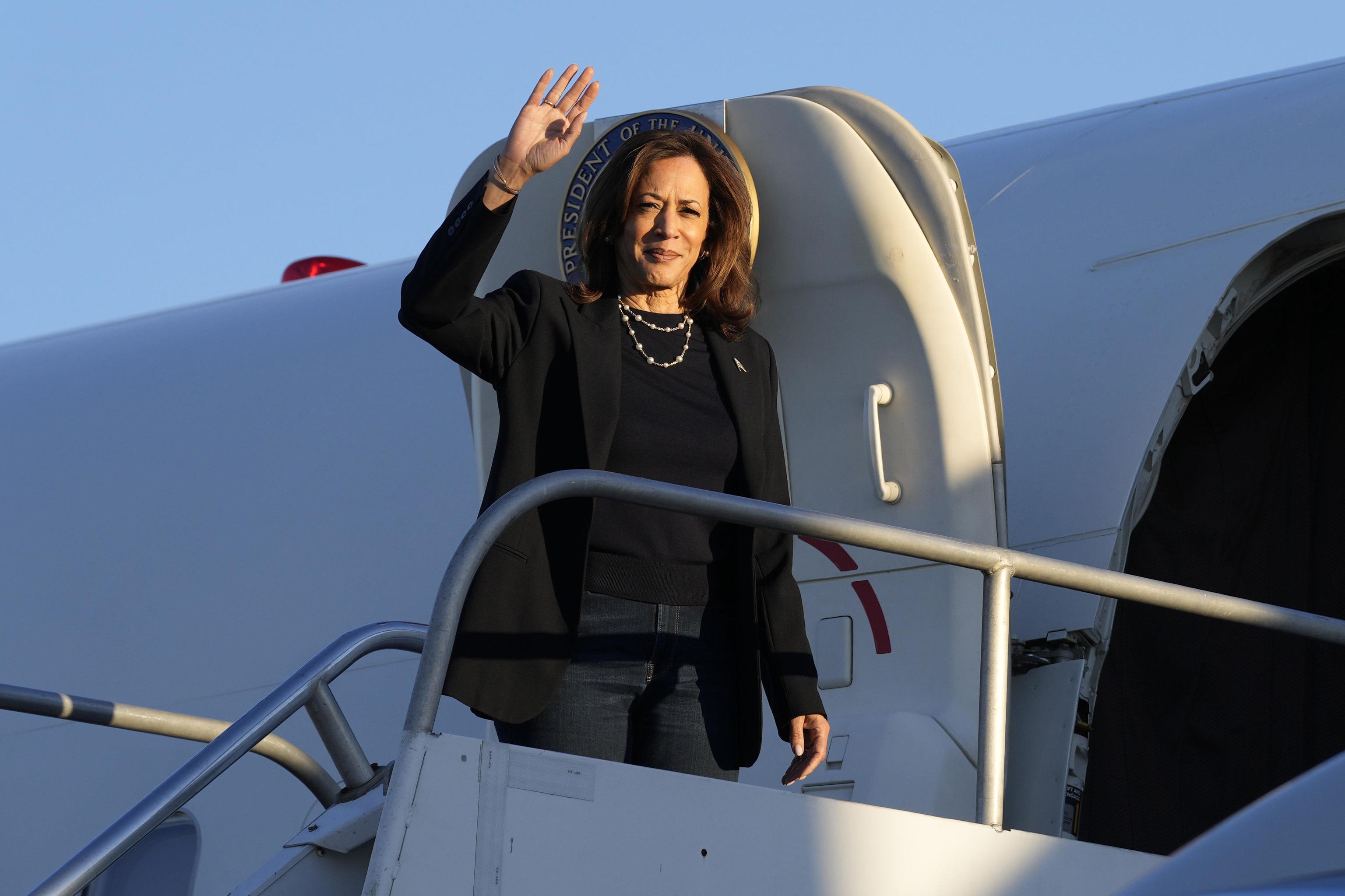 Kamala Harris waves as she boards Air Force Two at Philadelphia airport.