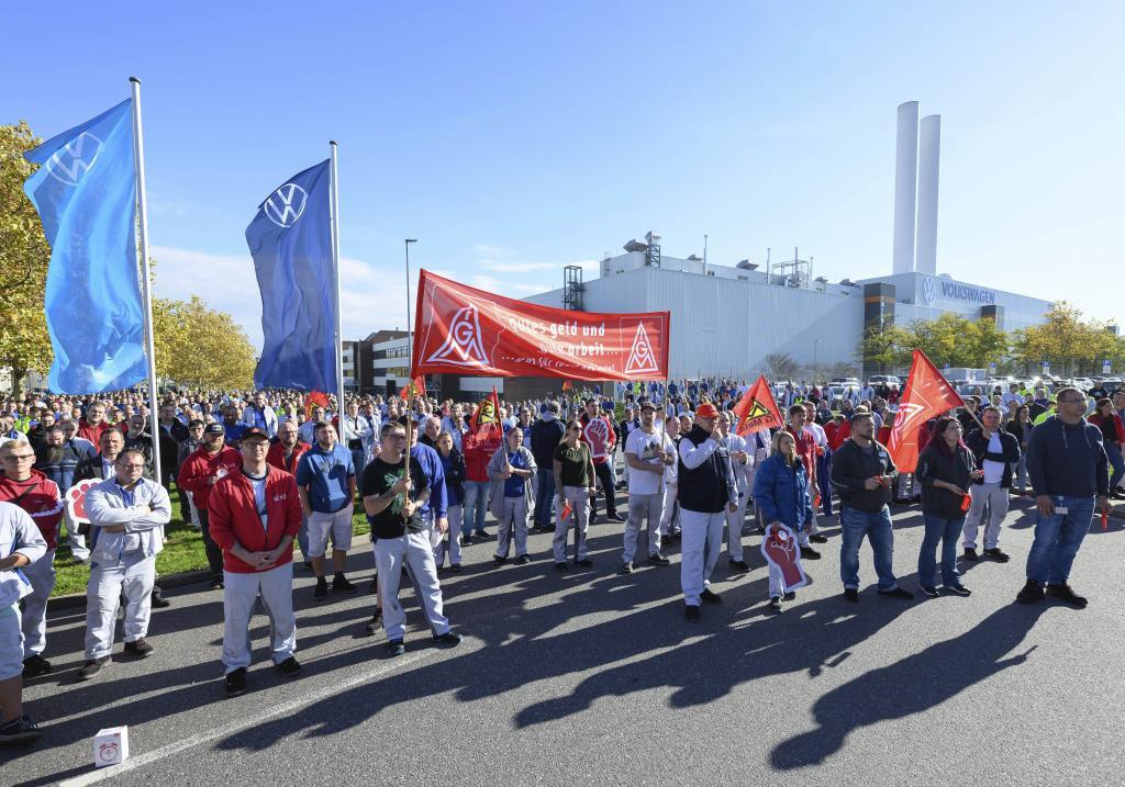 Volkswagen employees gather at the factory gate.